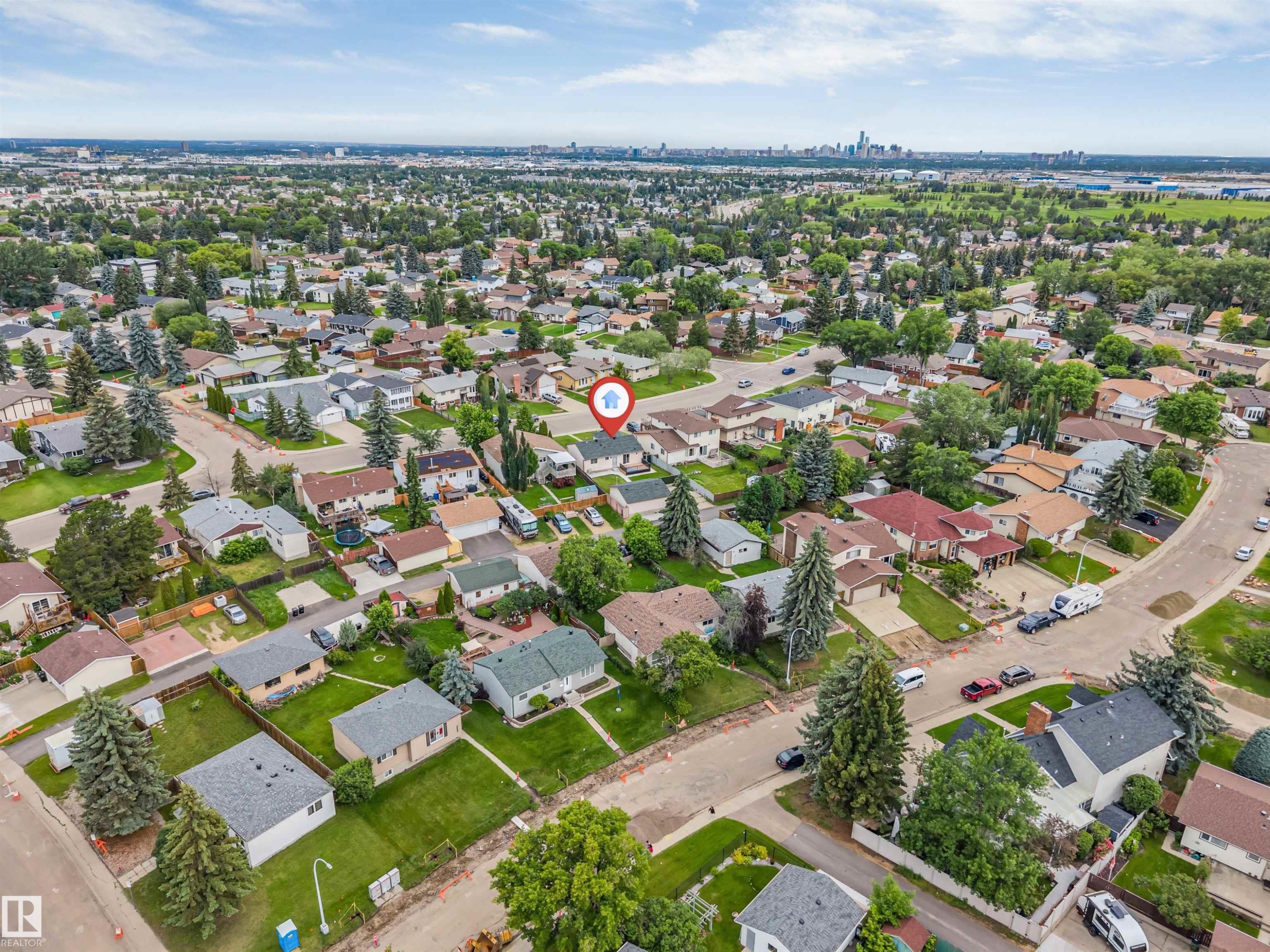 Aerial perspective of a residential neighborhood with a distant cityscape - 193 Woodvale Road W, Edmonton, AB