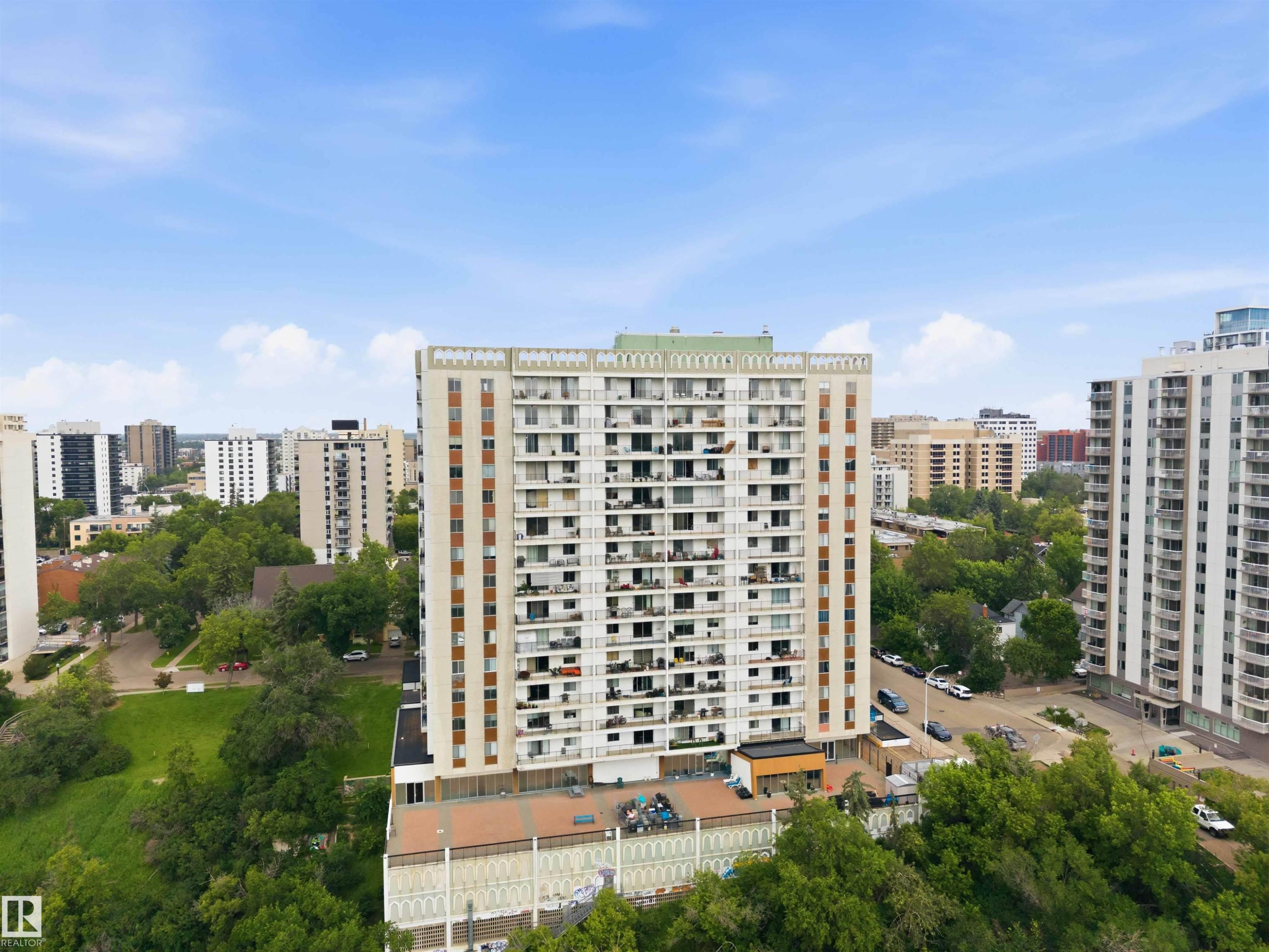High-rise condominium building featuring multiple balconies, a flat roofline, and a neutral-toned facade - #1008 11307 99 Av Nw, Edmonton, AB