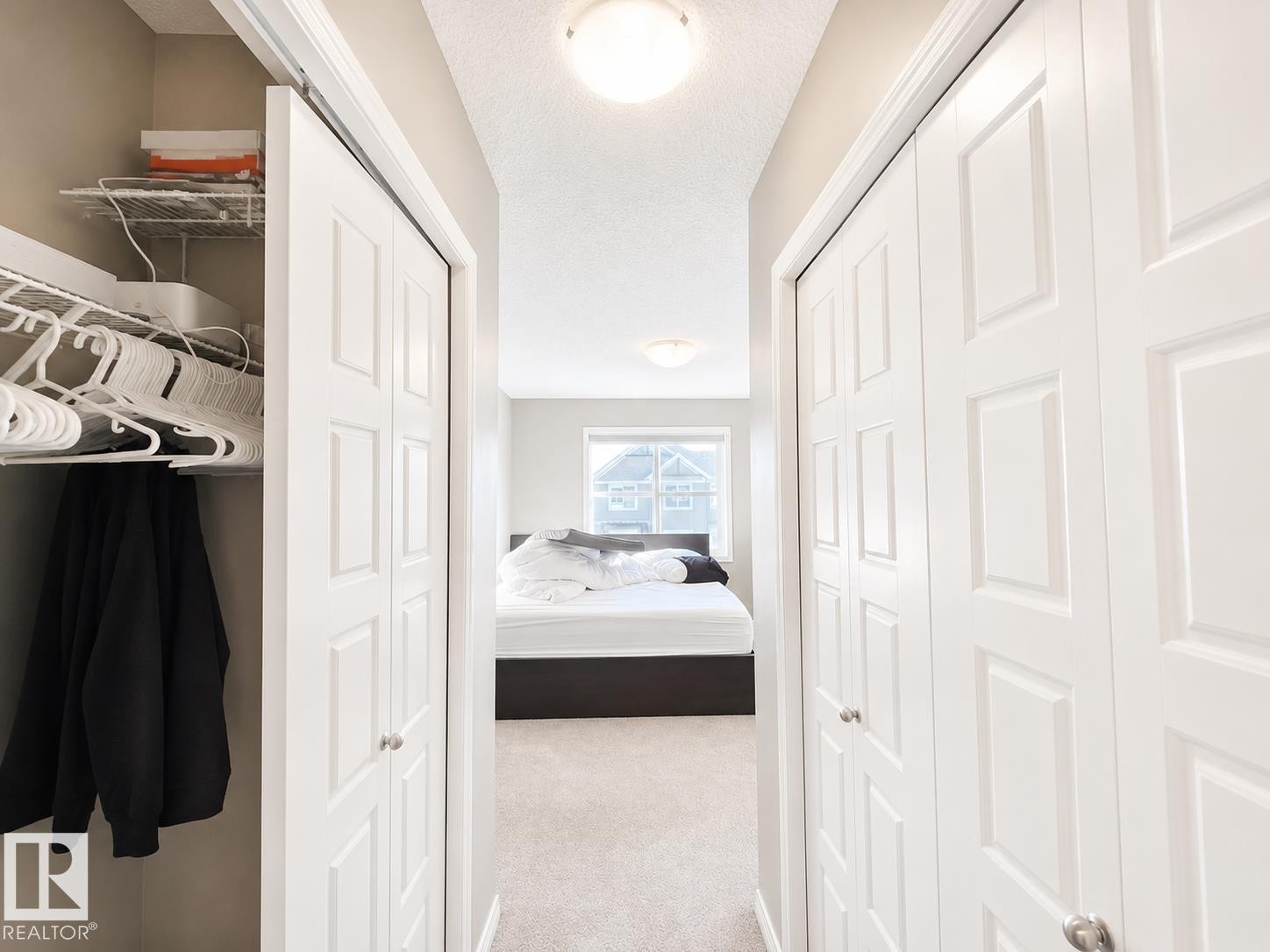 Hallway with neutral carpeting and light gray walls - 20104 19 Avenue, Edmonton, AB
