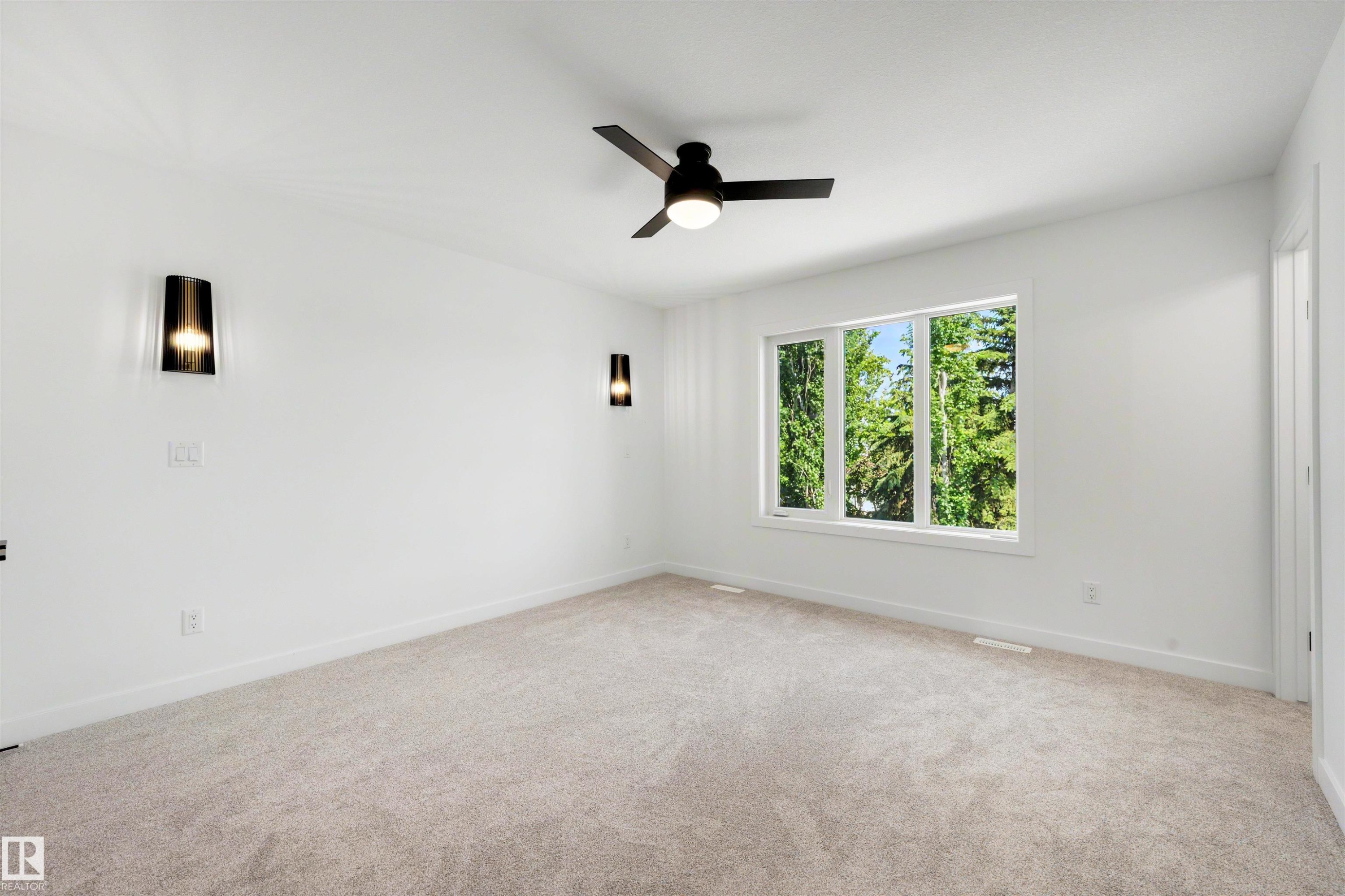Carpeted room with a multi-pane window and a black ceiling fan - 30 Elsinore Place Nw, Edmonton, AB