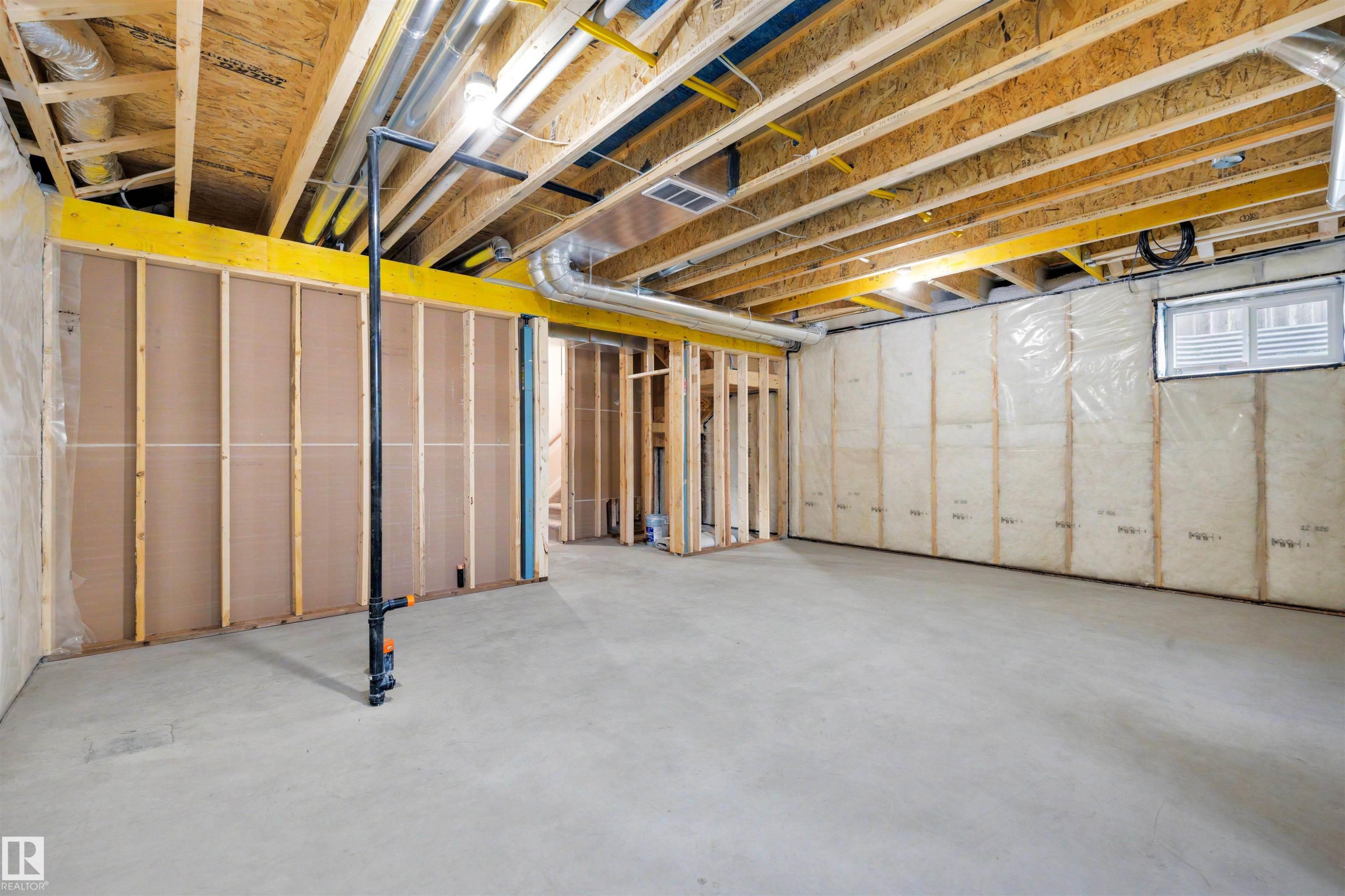 Unfinished basement with concrete flooring and exposed ceiling joists - 30 Elsinore Place Nw, Edmonton, AB