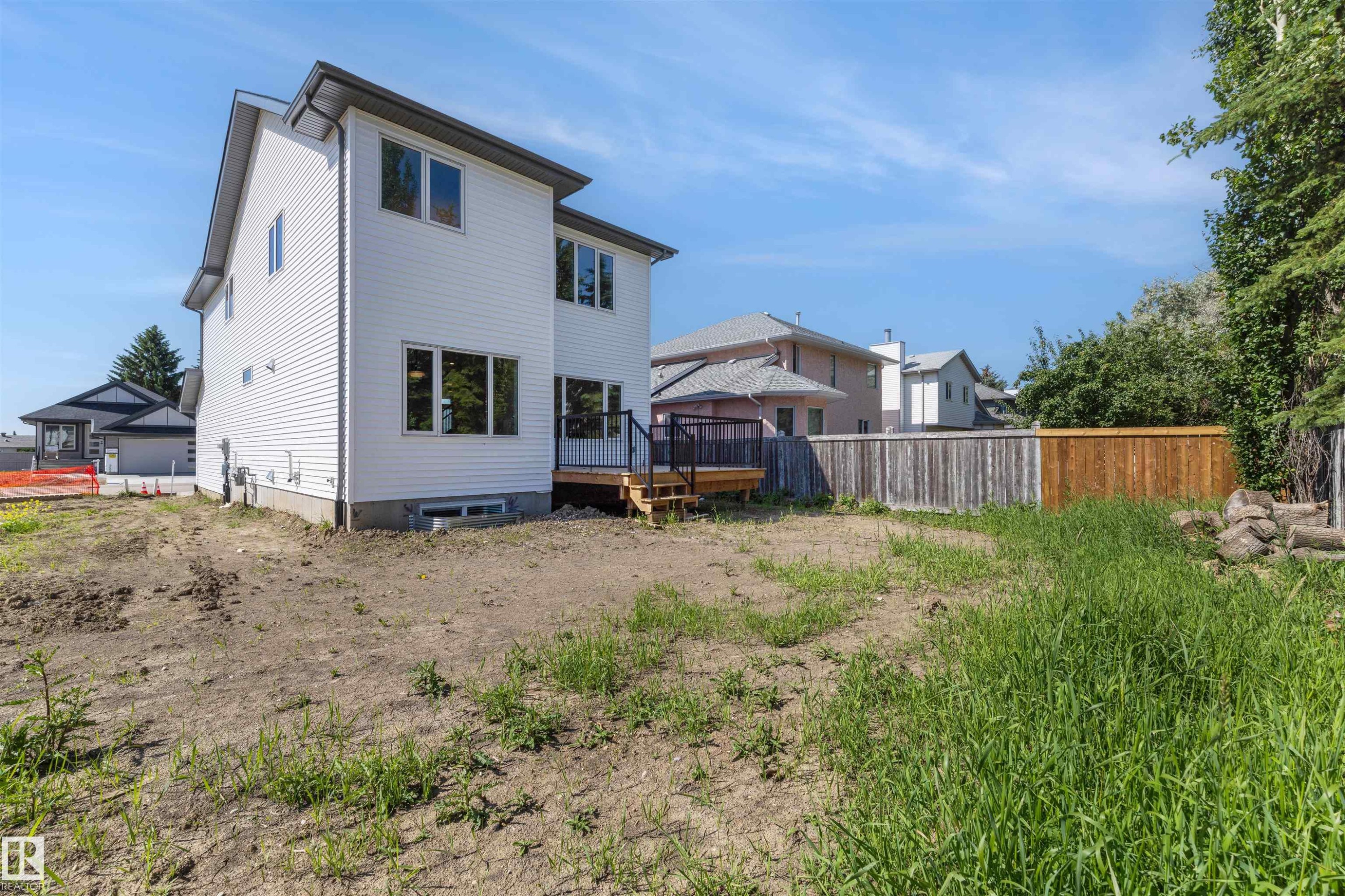 Rear exterior featuring white horizontal siding and a dark roofline - 30 Elsinore Place Nw, Edmonton, AB