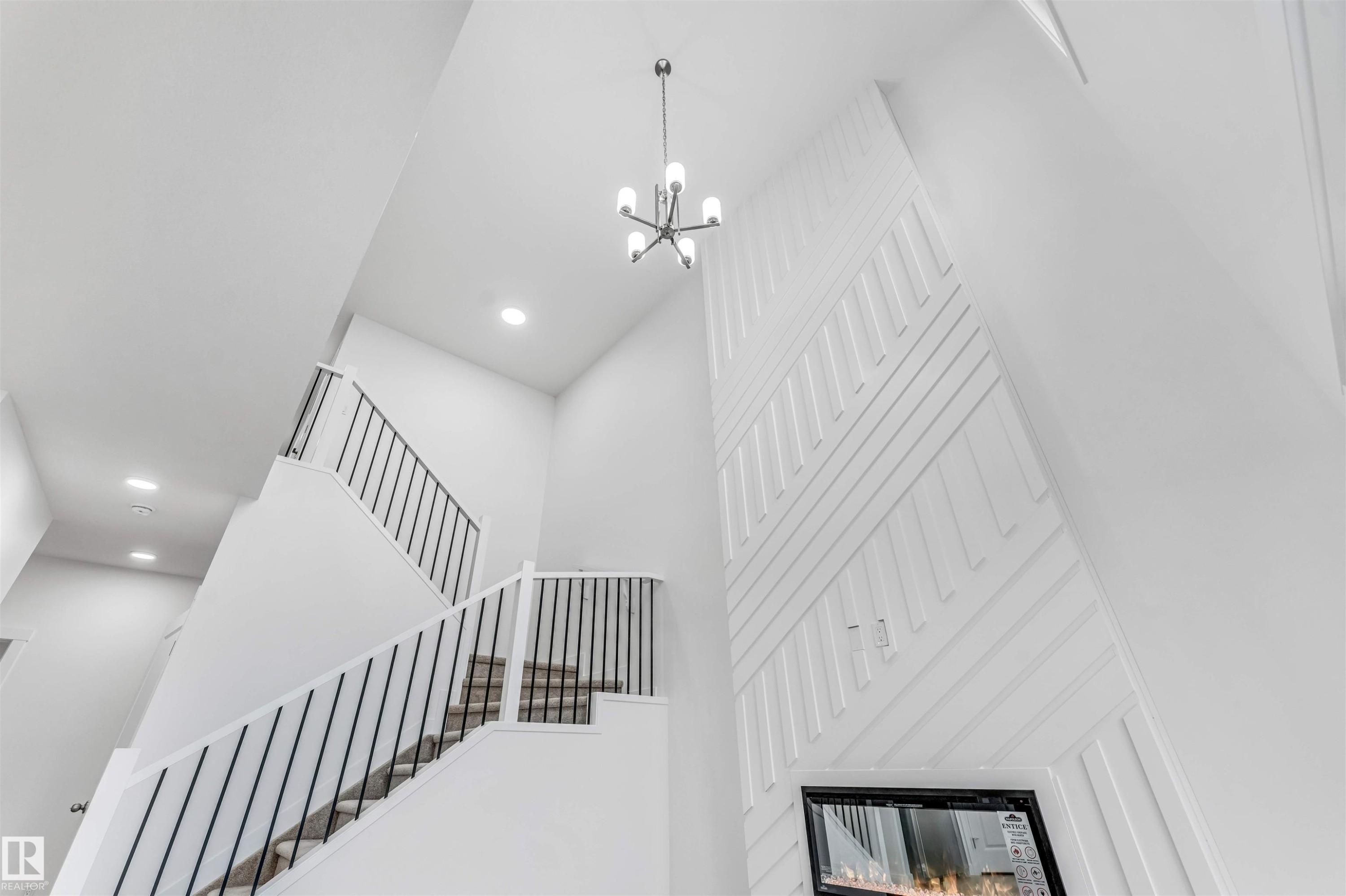 Two-story ceiling with recessed lighting and a contemporary chandelier - 1972 210 Street, Edmonton, AB