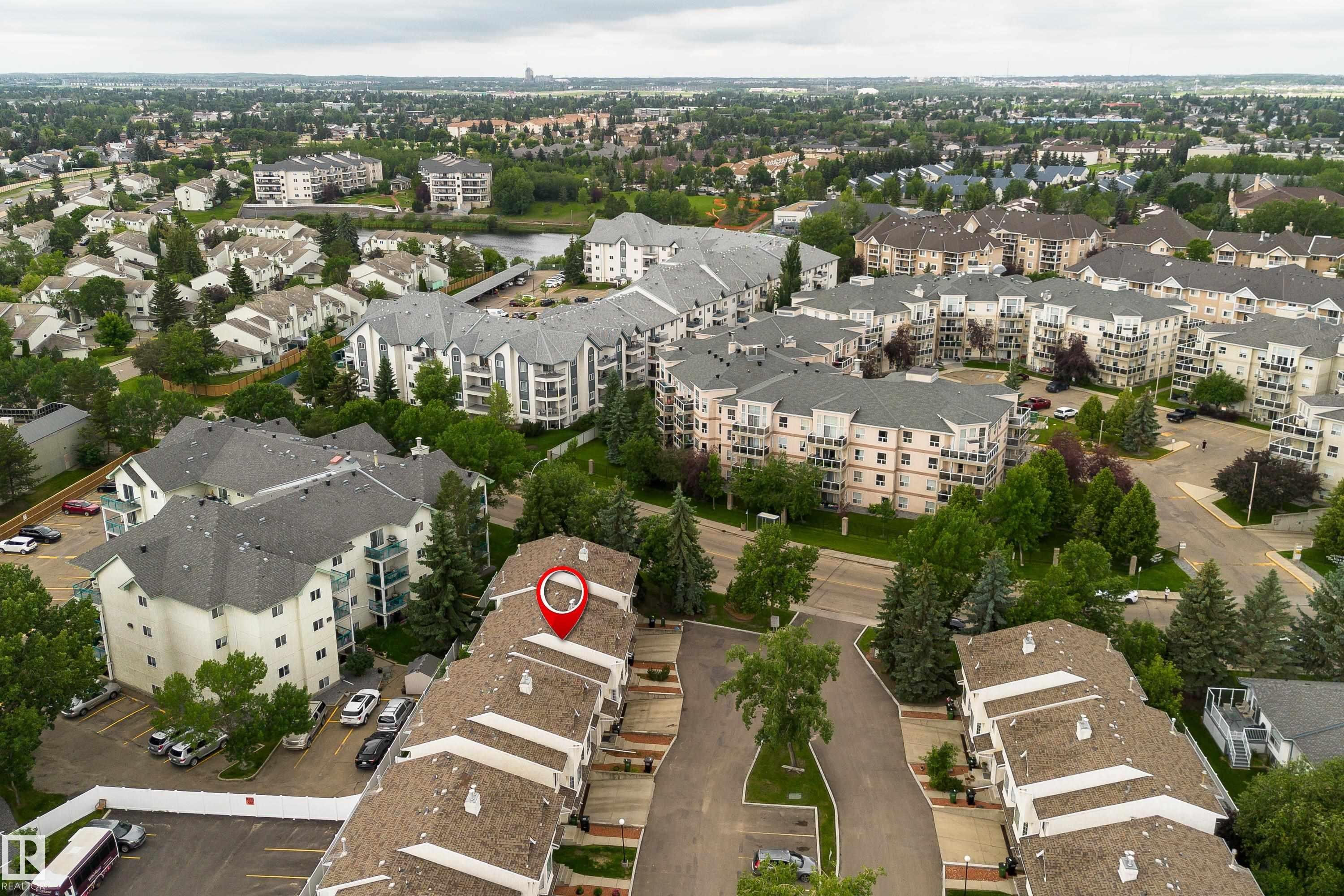 Aerial view of a residential community featuring townhomes and multi-story apartment buildings - 3 9703 174 Street, Edmonton, AB