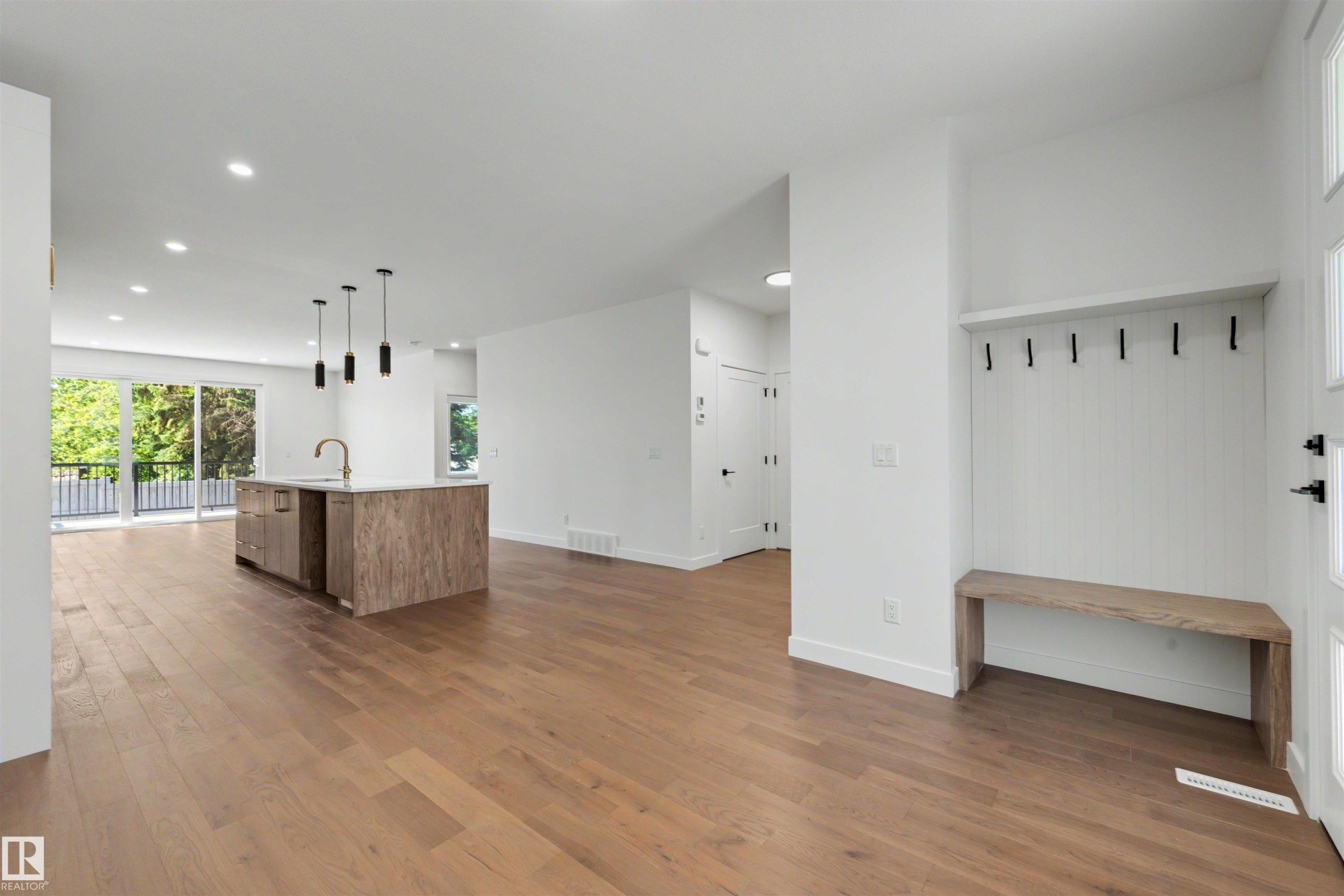 Bright, open-concept living space featuring wood-finish flooring throughout - 39 Elsinore Place, Edmonton, AB
