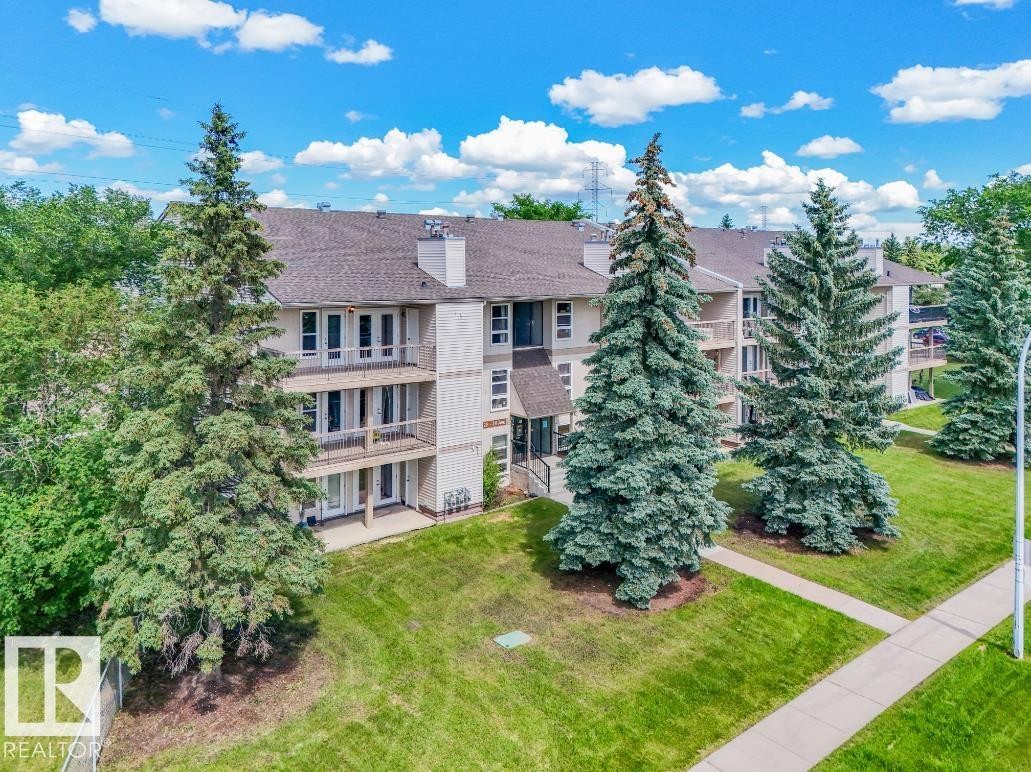 Multi-story building featuring balconies on upper levels and patios on the ground level - #301 10528 29 Av Nw, Edmonton, AB