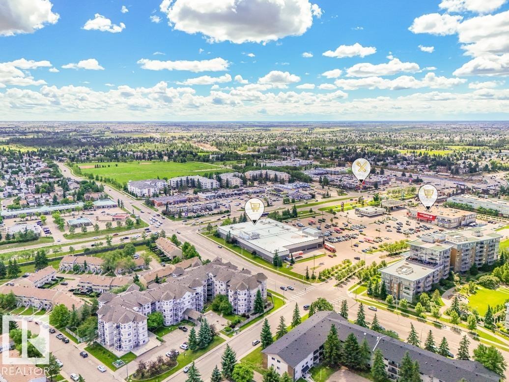 Aerial perspective showcasing a developed urban area with commercial and residential properties - #301 10528 29 Av Nw, Edmonton, AB