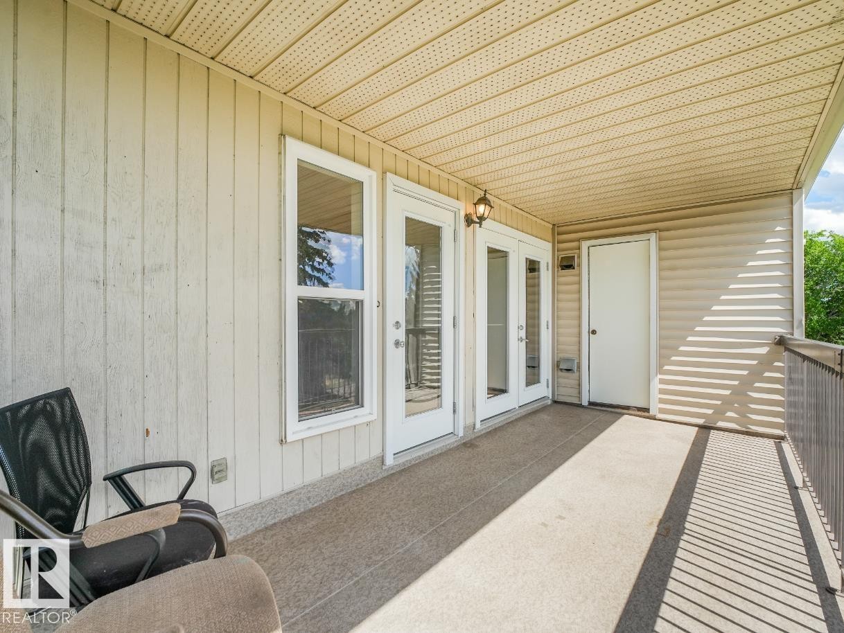 Covered balcony featuring textured concrete flooring - #301 10528 29 Av Nw, Edmonton, AB