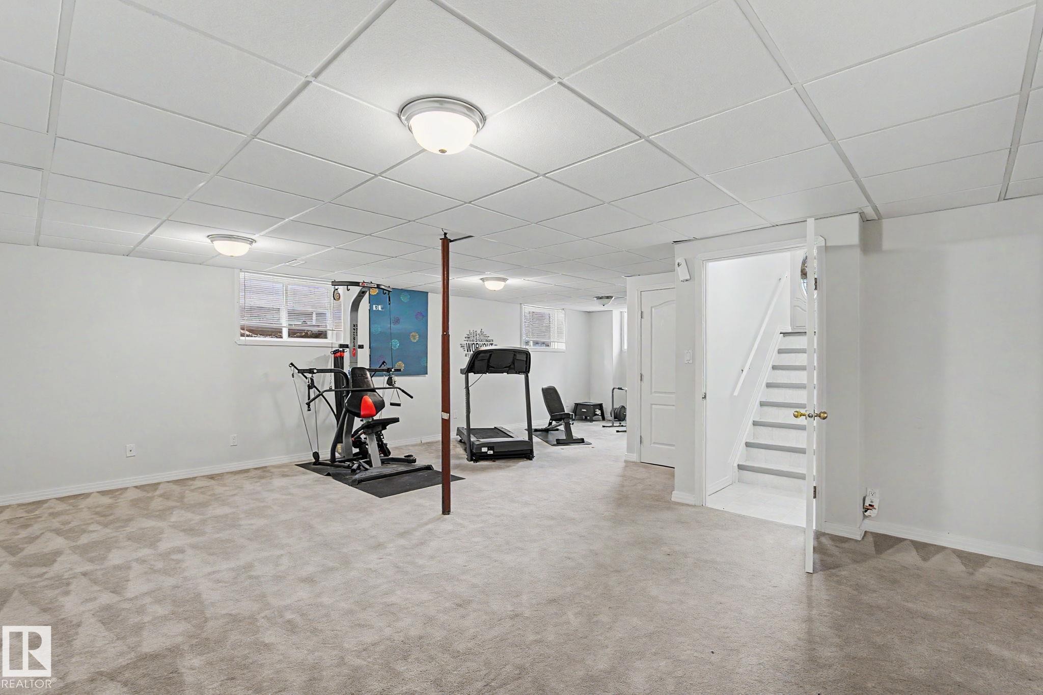 Finished lower level featuring recessed lighting, a drop ceiling, and carpeted flooring - 1619 Welbourn Cove, Edmonton, AB