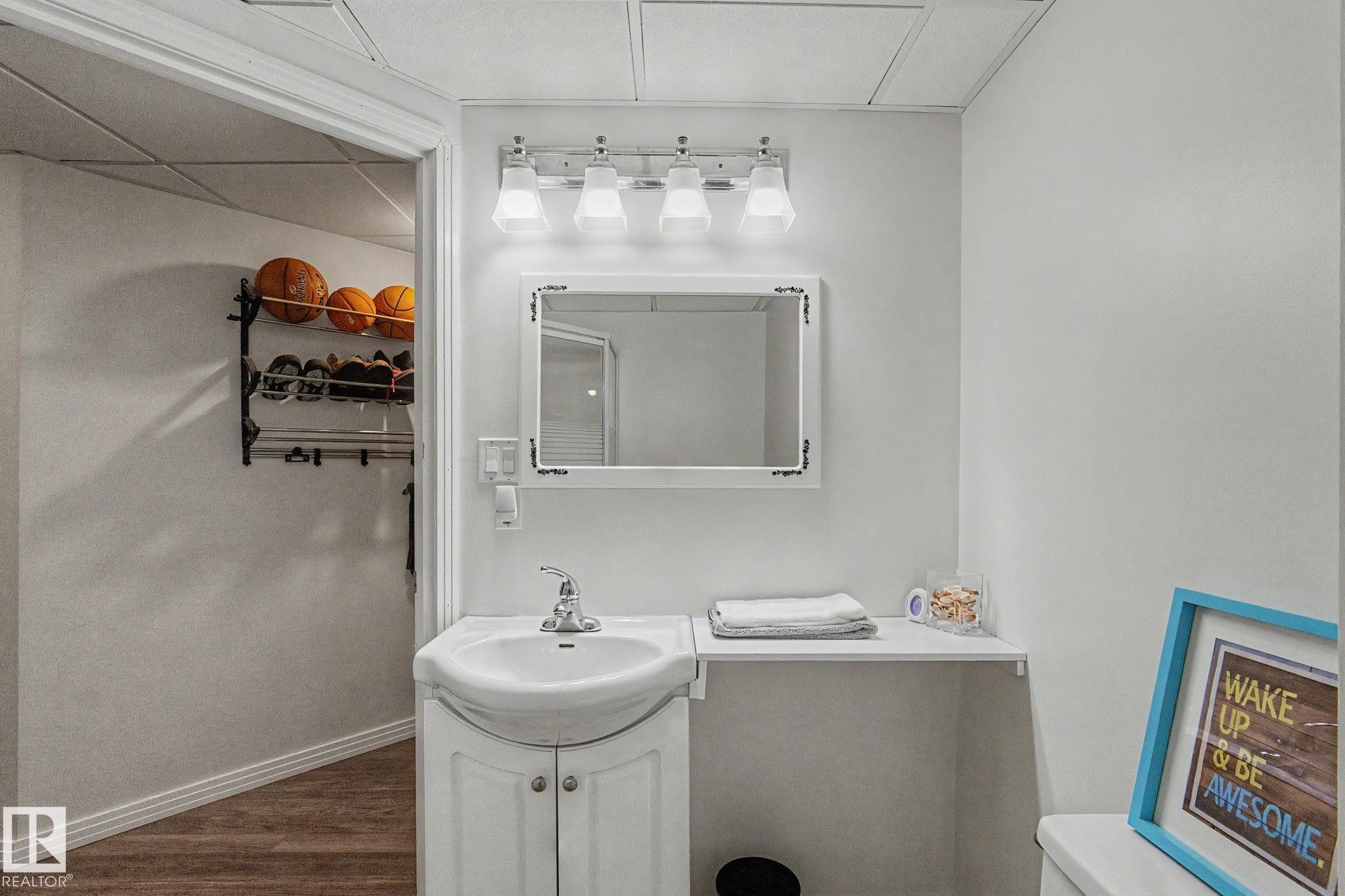 Vanity area featuring a white pedestal sink with cabinet storage - 1619 Welbourn Cove, Edmonton, AB