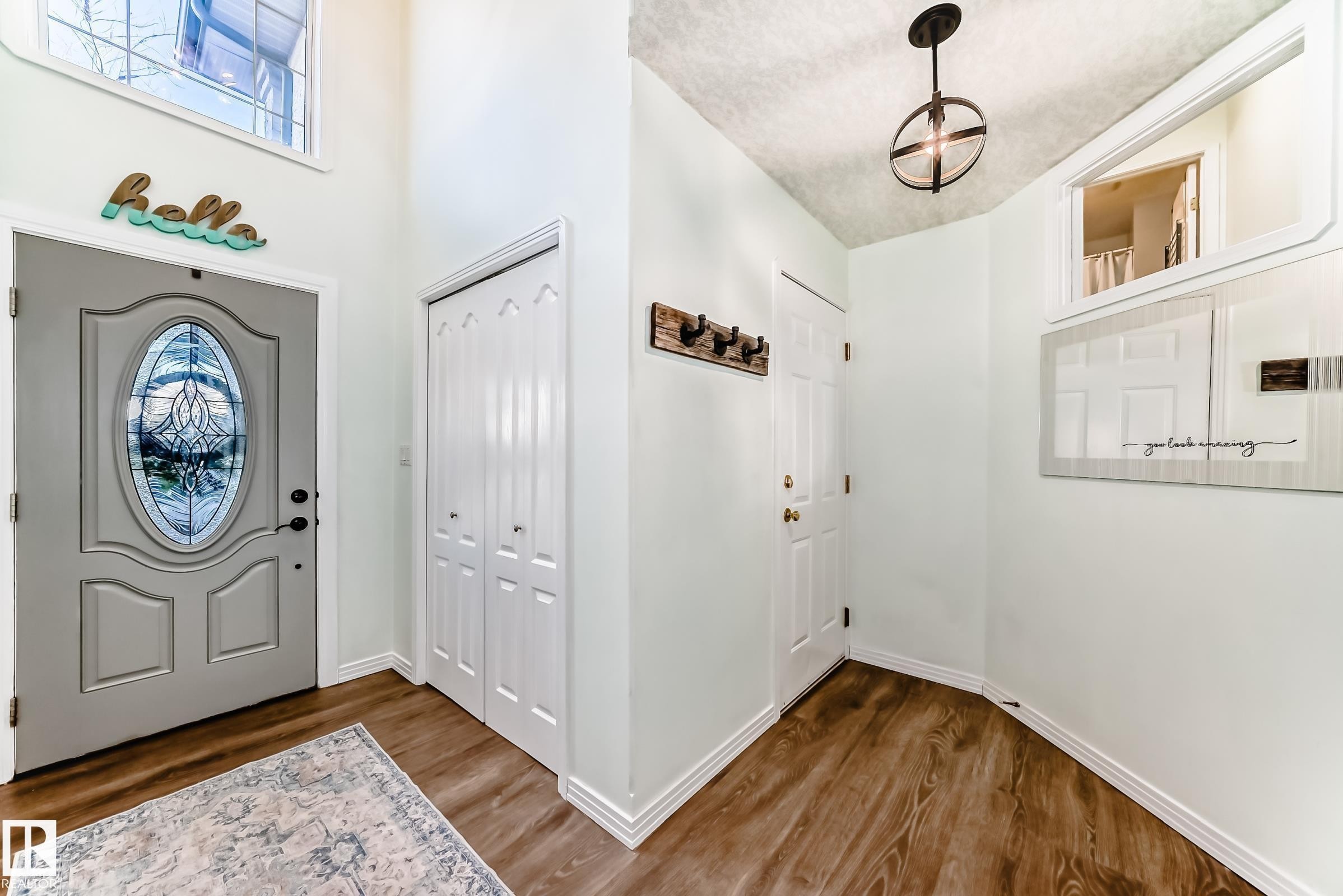 Entryway with wood-finish flooring and a decorative door featuring stained glass - 1619 Welbourn Cove, Edmonton, AB