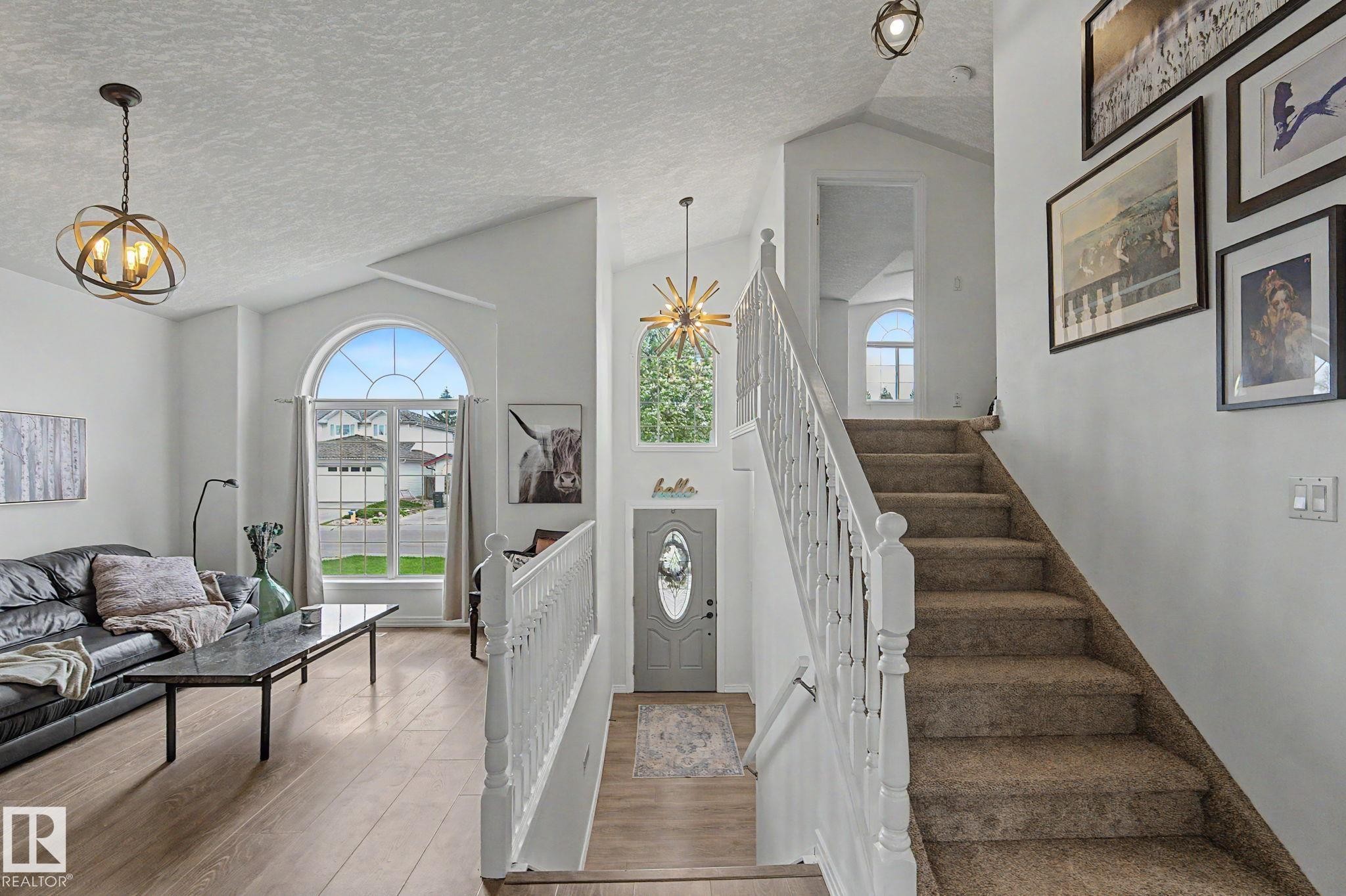 Vaulted ceilings with contemporary lighting fixtures - 1619 Welbourn Cove, Edmonton, AB
