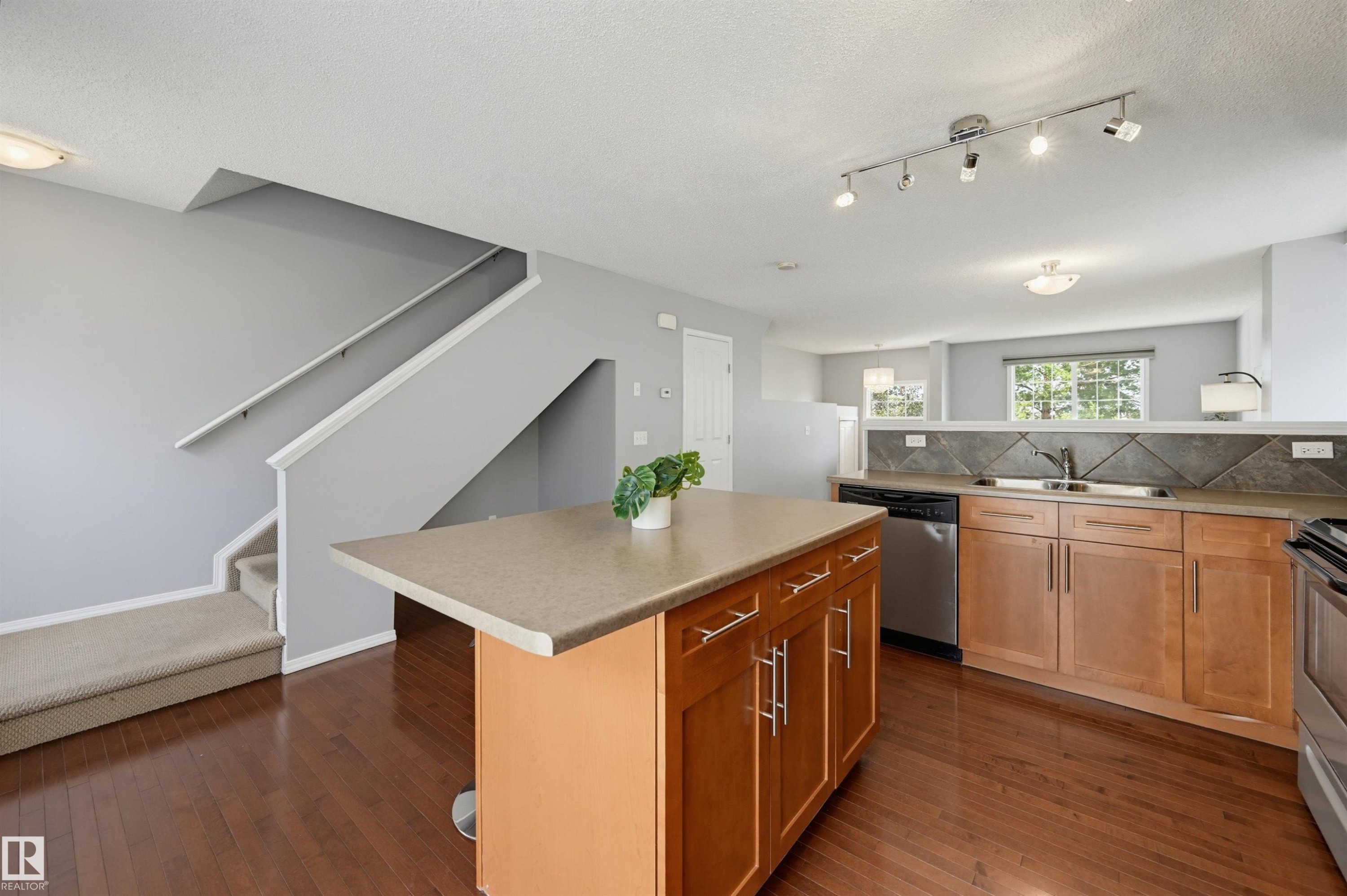 Kitchen with a central island featuring cabinetry storage - 126 2051 Towne Centre Boulevard, Edmonton, AB