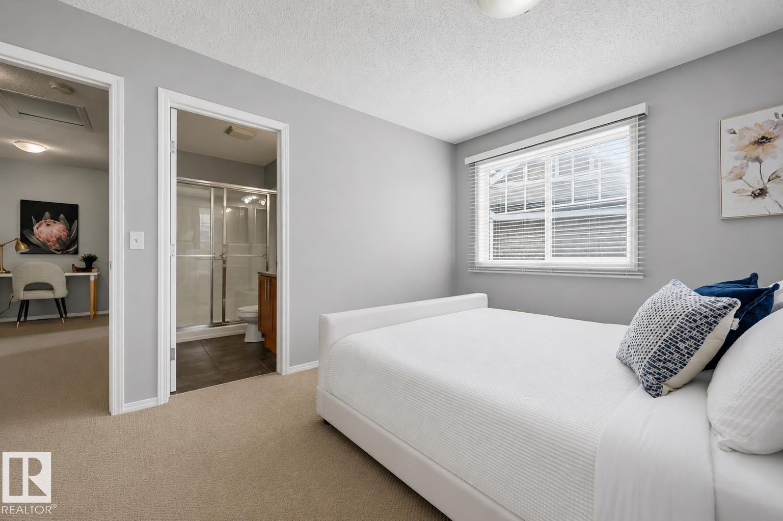 Bedroom featuring neutral wall colors, carpet flooring, a window with horizontal blinds, and direct access to a bathroom with a glass-enclosed shower - 126 2051 Towne Centre Boulevard, Edmonton, AB