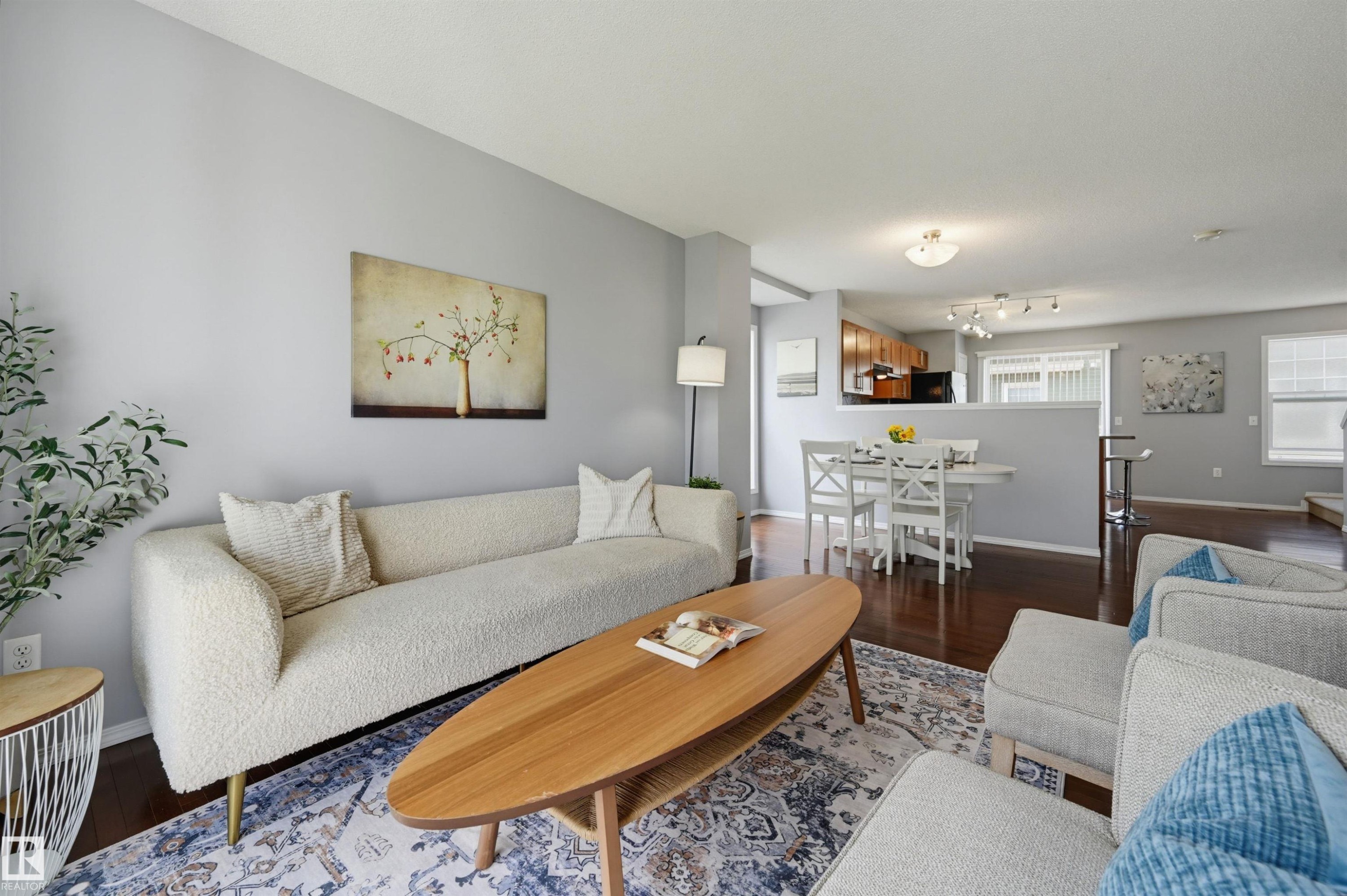 Open-concept living space featuring wood-finish flooring, light gray wall tones, and recessed lighting - 126 2051 Towne Centre Boulevard, Edmonton, AB