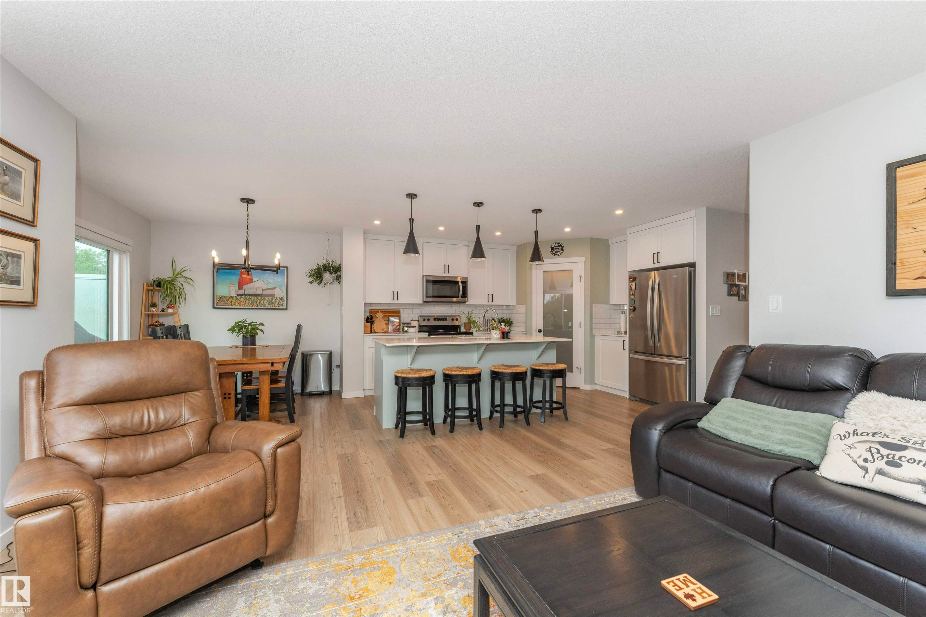Open-concept living space featuring wood-finish flooring - 102 Horton Way, Ardrossan, AB