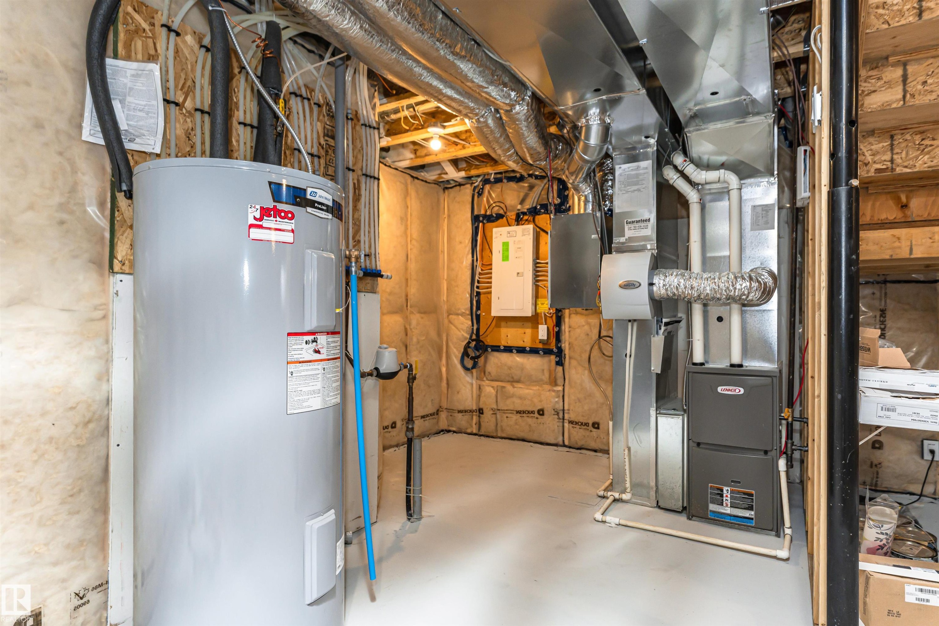 Utility space featuring a water heater, furnace, and exposed ductwork - 102 Horton Way, Ardrossan, AB
