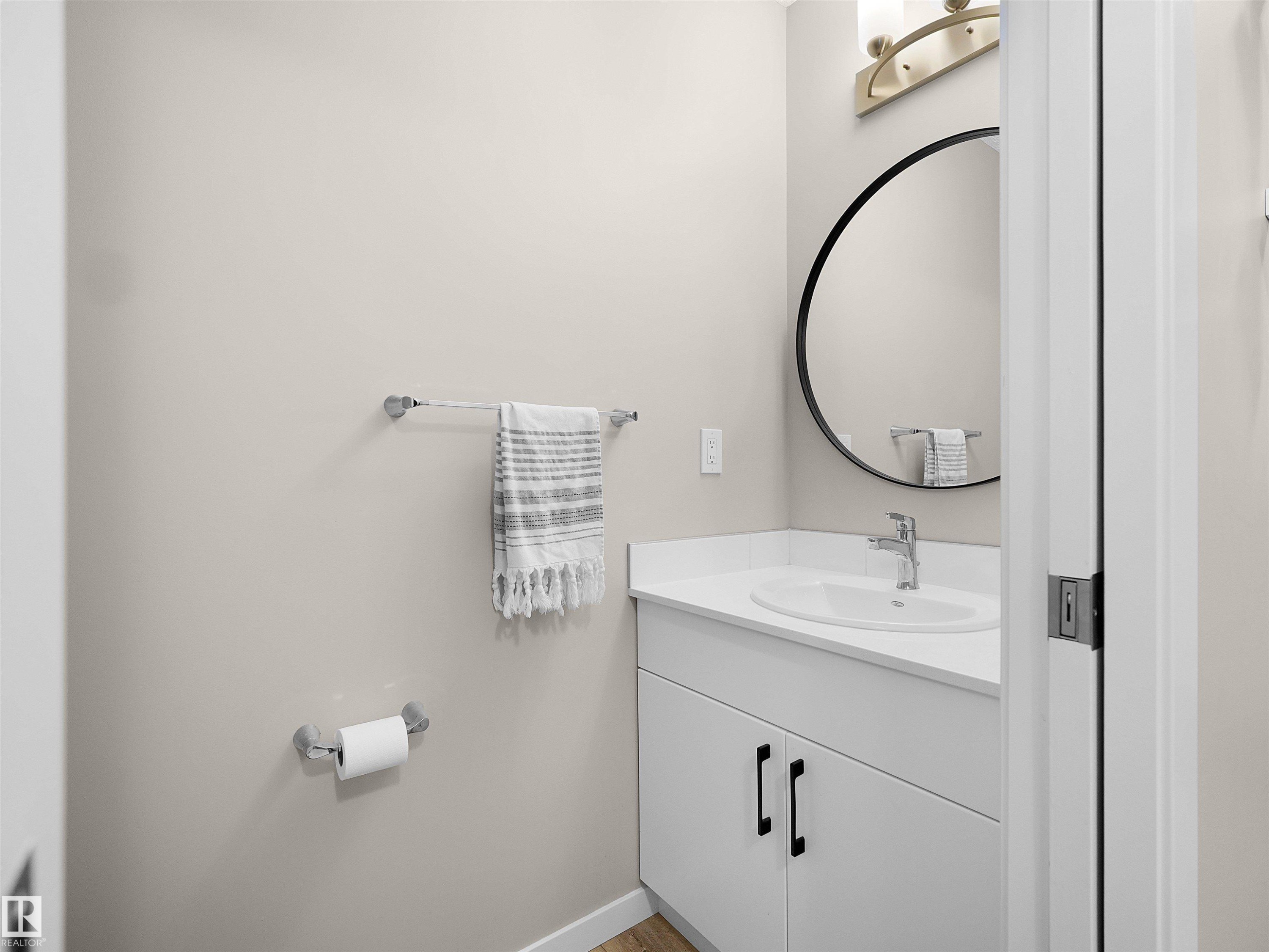 Contemporary bathroom vanity featuring a white countertop, undermount sink, and matte black hardware - #49 17832 78 St Nw, Edmonton, AB - Indoor Photo Showing Bathroom