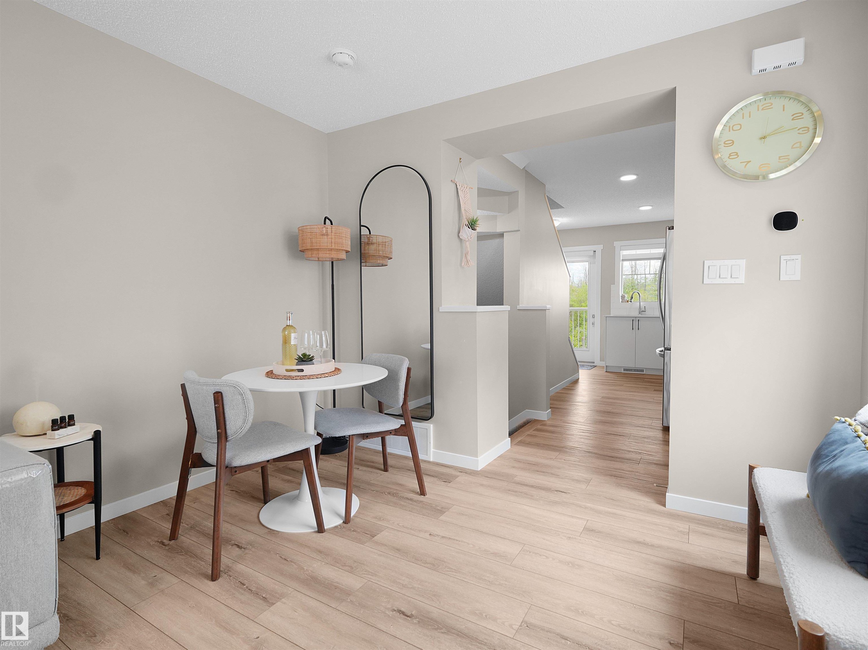 Open-concept living area featuring wood-finish flooring, neutral wall tones, and recessed lighting - #49 17832 78 St Nw, Edmonton, AB - Indoor