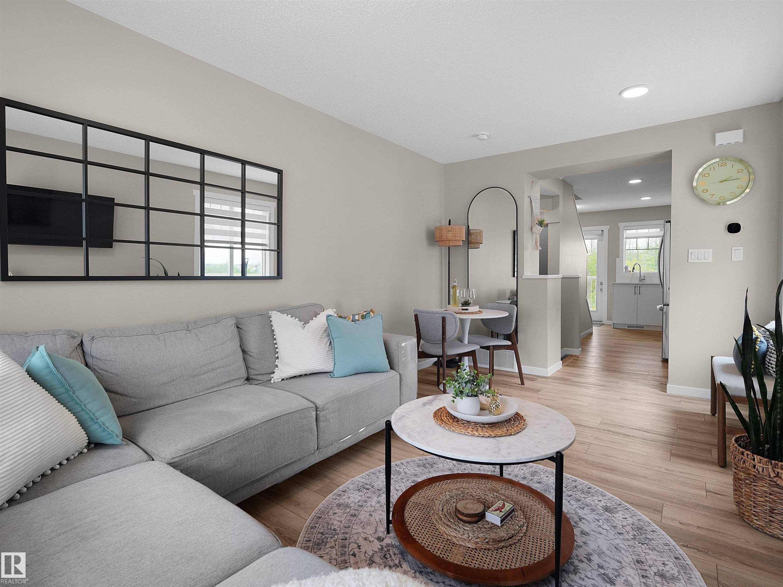 Open-concept living area with light wood-finish flooring, recessed lighting, and a neutral wall palette - #49 17832 78 St Nw, Edmonton, AB - Indoor Photo Showing Living Room