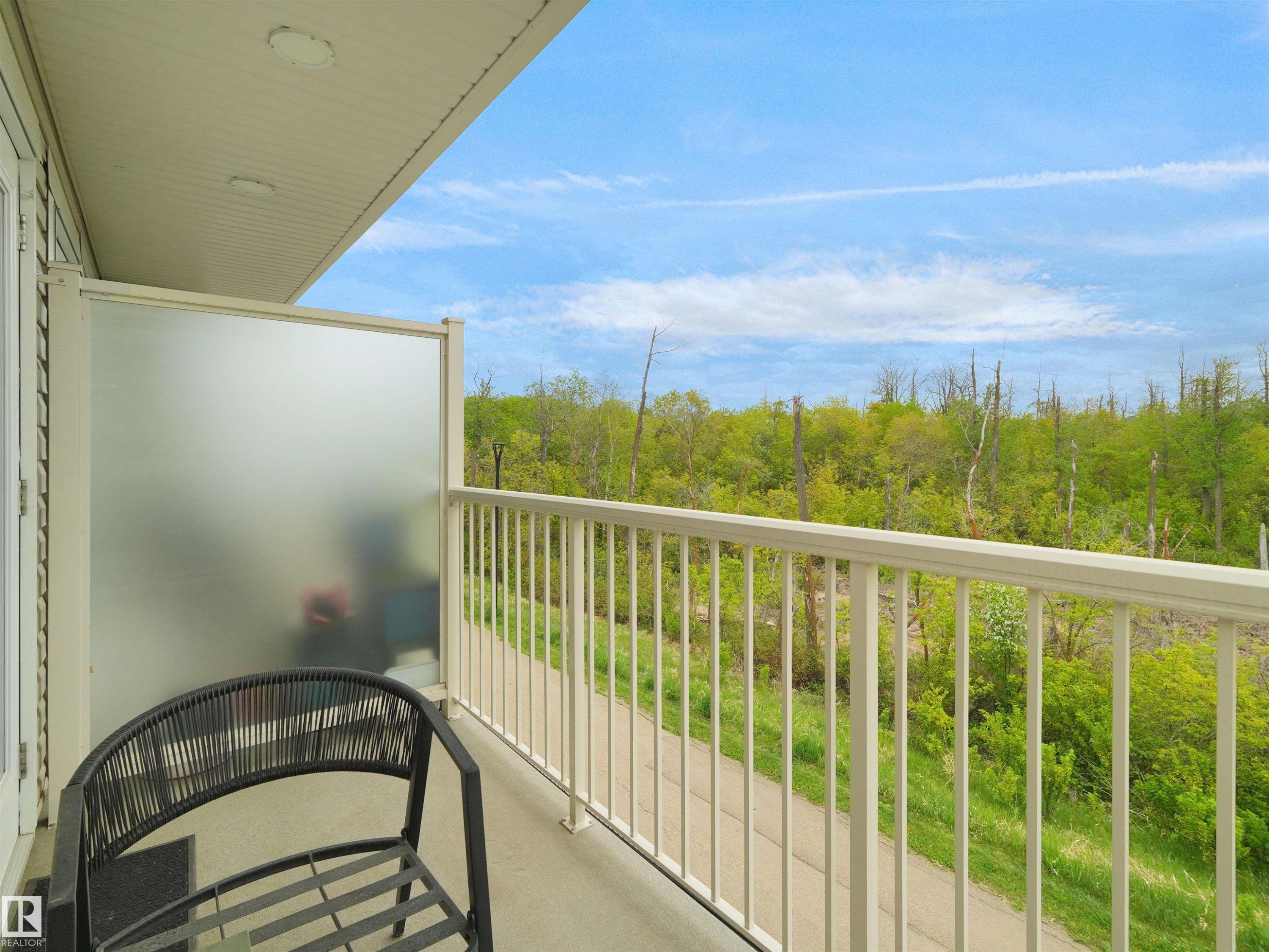 Private balcony featuring a frosted privacy panel, white railing, and concrete flooring - #49 17832 78 St Nw, Edmonton, AB - Outdoor With Balcony With Exterior