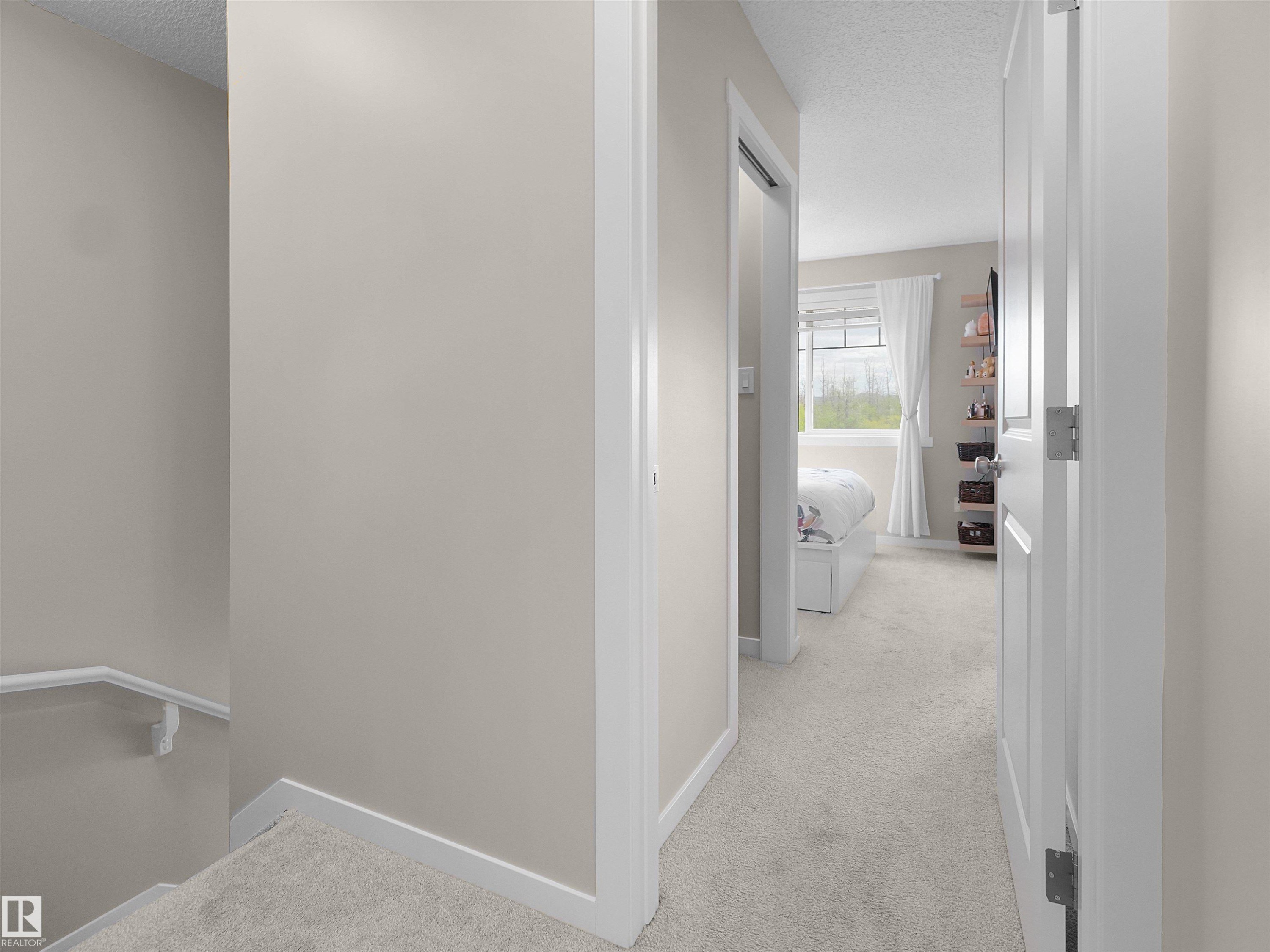 Carpeted hallway with light neutral wall paint and white trim - #49 17832 78 St Nw, Edmonton, AB - Indoor Photo Showing Other Room