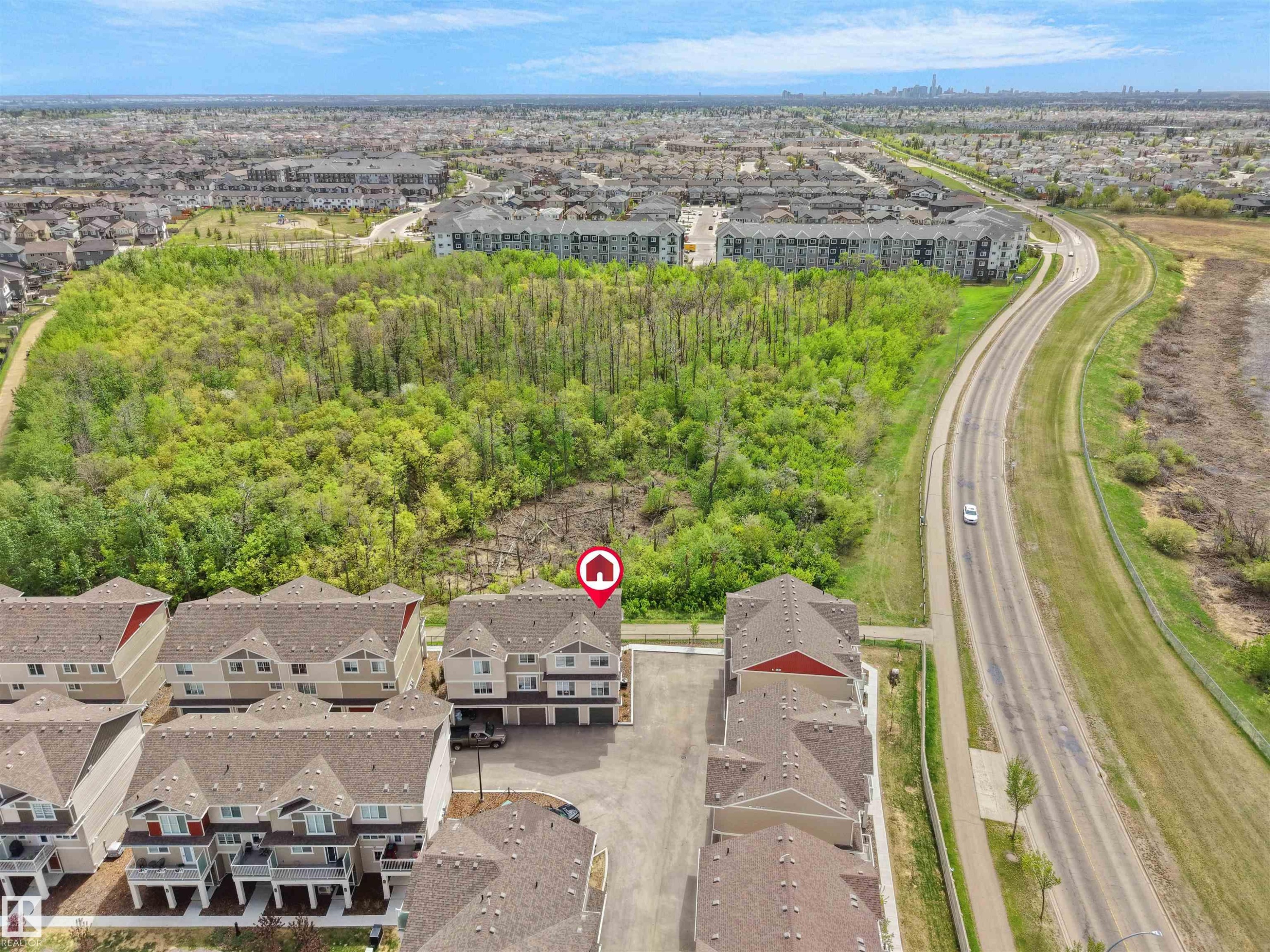 Aerial perspective showcasing a multi-story townhome with an attached garage - #49 17832 78 St Nw, Edmonton, AB - Outdoor With View