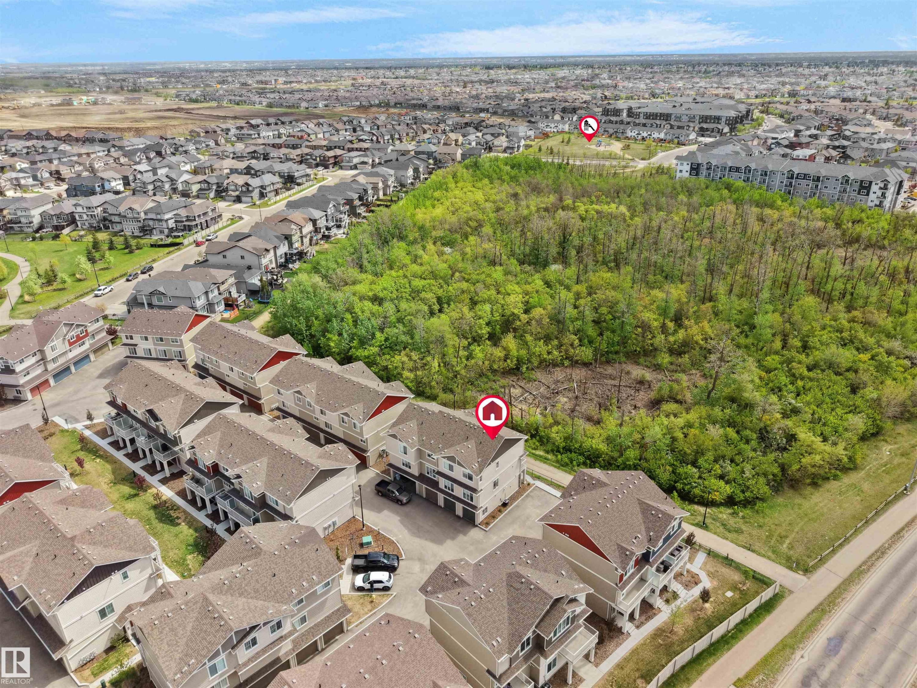 Aerial perspective showcasing a residential development with multi-story townhomes and single-family residences - #49 17832 78 St Nw, Edmonton, AB - Outdoor With View
