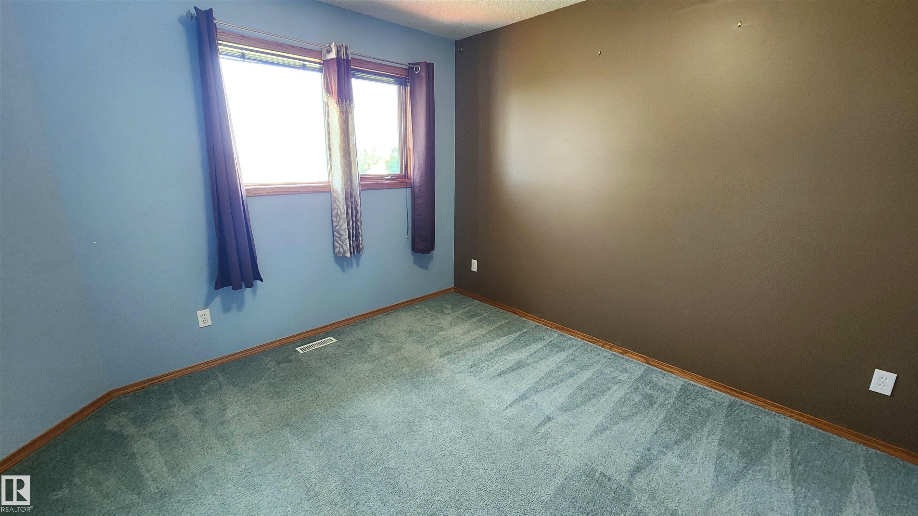 Interior room featuring carpet flooring, two-tone walls, and a window with wood-finish trim - 2708 44A Avenue, Edmonton, AB