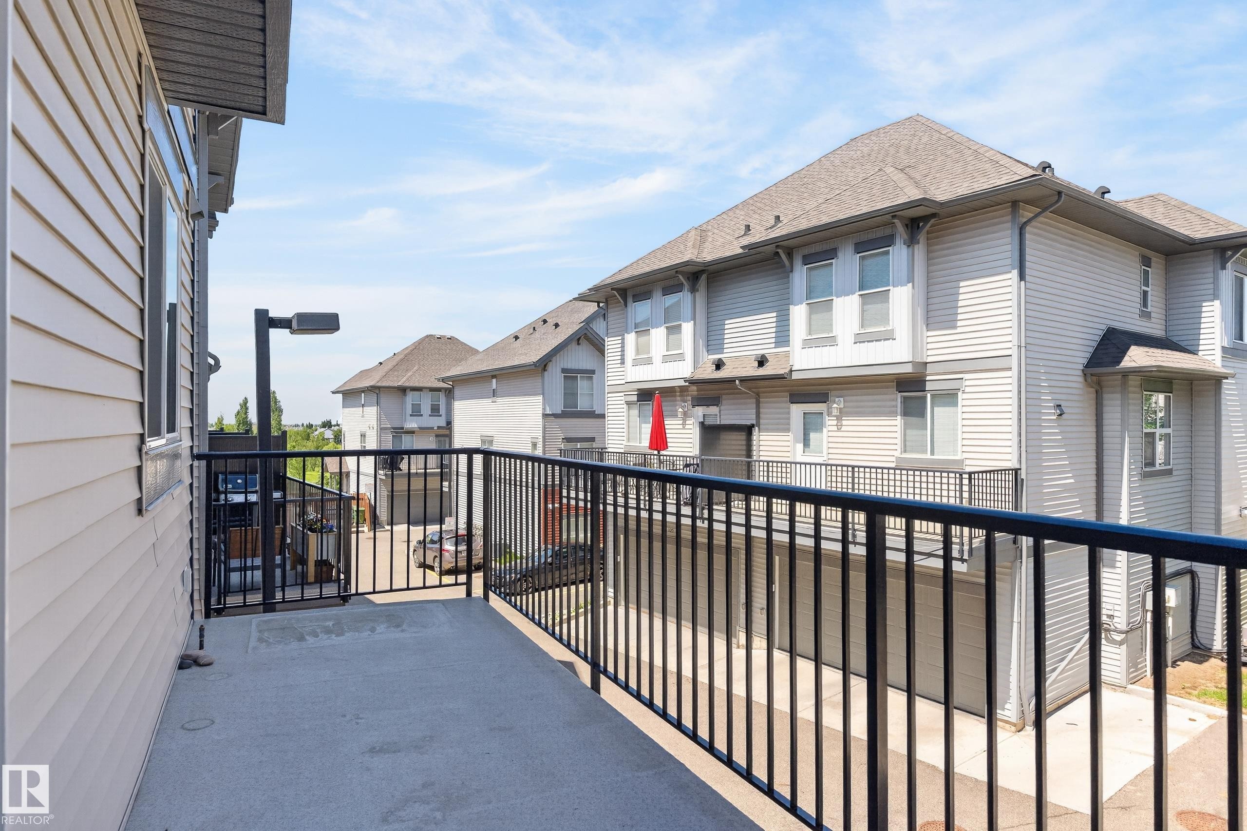 Private balcony with concrete flooring and black metal railings - 24 655 Watt Boulevard, Edmonton, AB