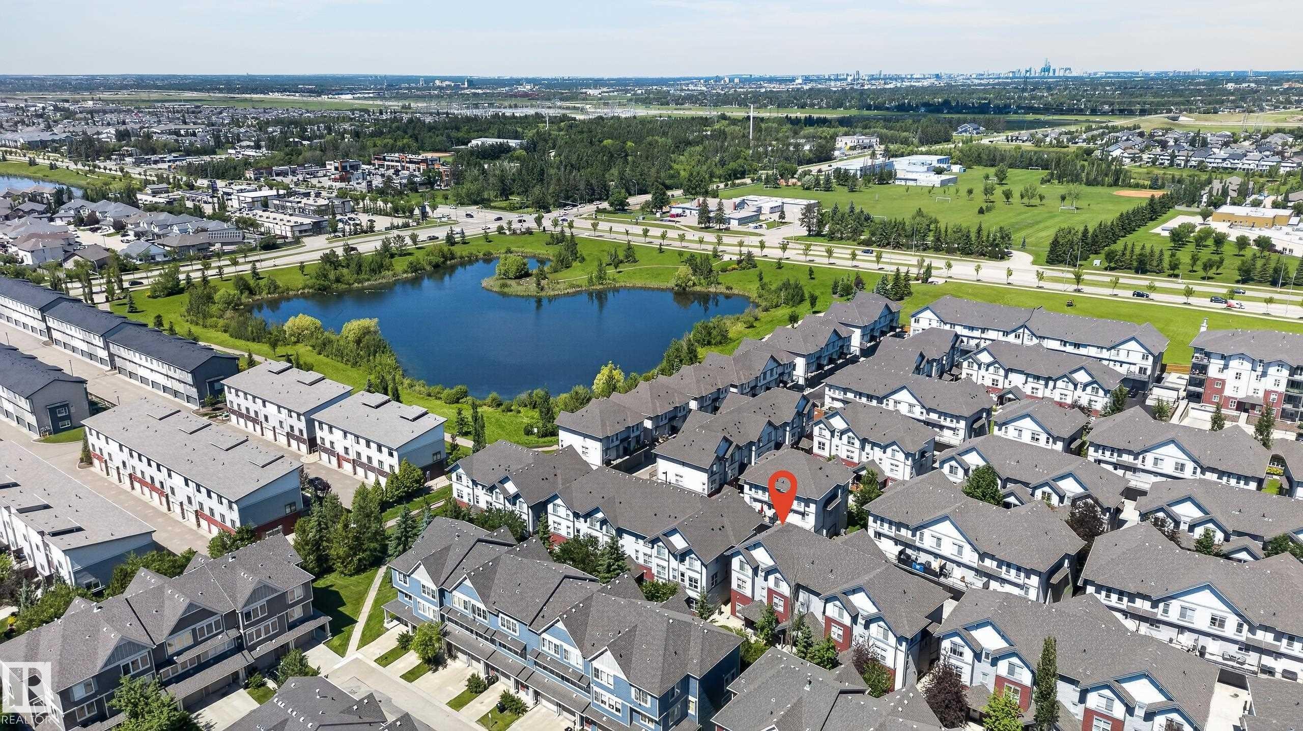 Aerial perspective showcasing a residential community with townhomes and detached properties - 24 655 Watt Boulevard, Edmonton, AB