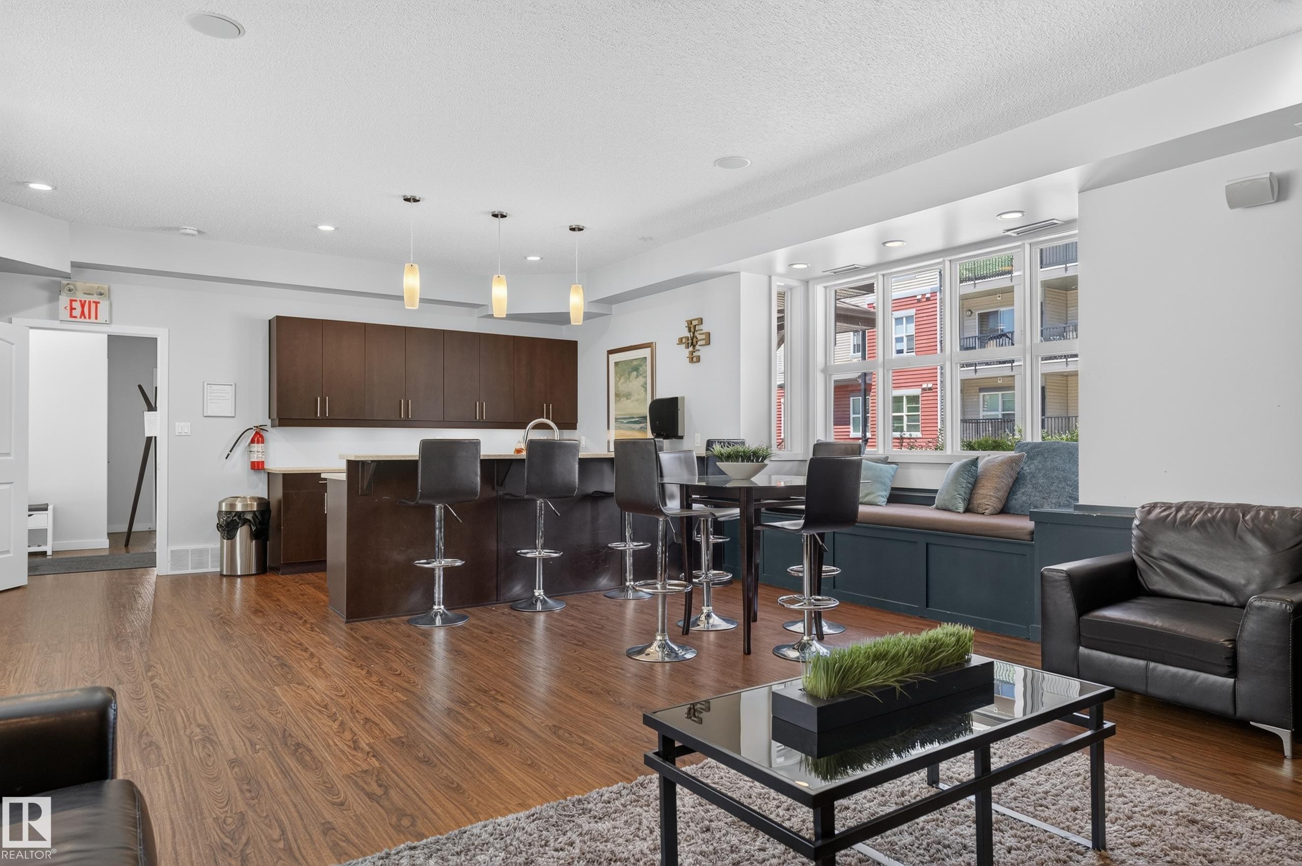 Open concept space featuring wood-finish flooring and a built-in window seat - 24 655 Watt Boulevard, Edmonton, AB