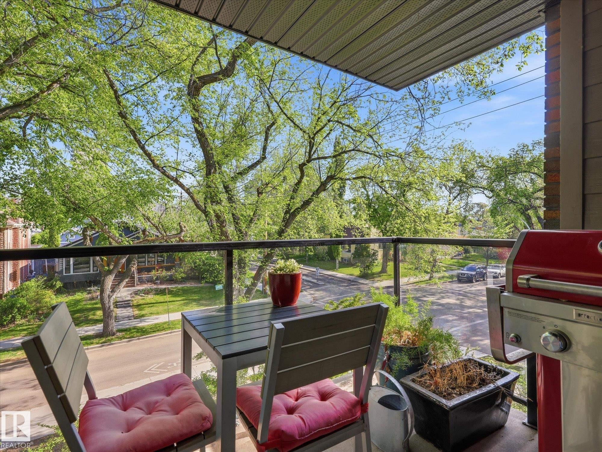Private balcony featuring a glass railing and slat wood ceiling - 301 10003 87 Avenue, Edmonton, AB - Outdoor With Deck Patio Veranda With Exterior