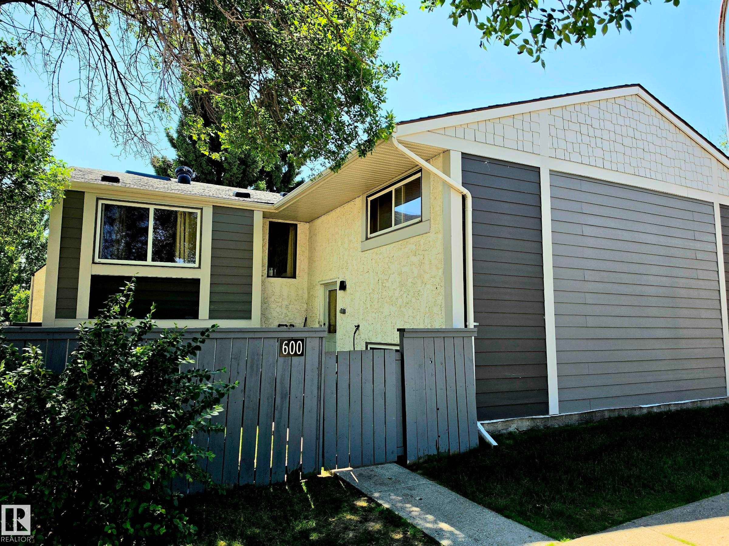Multi-level exterior with mixed siding, featuring horizontal panels and decorative shingles - 600 Willow Crest Nw, Edmonton, AB
