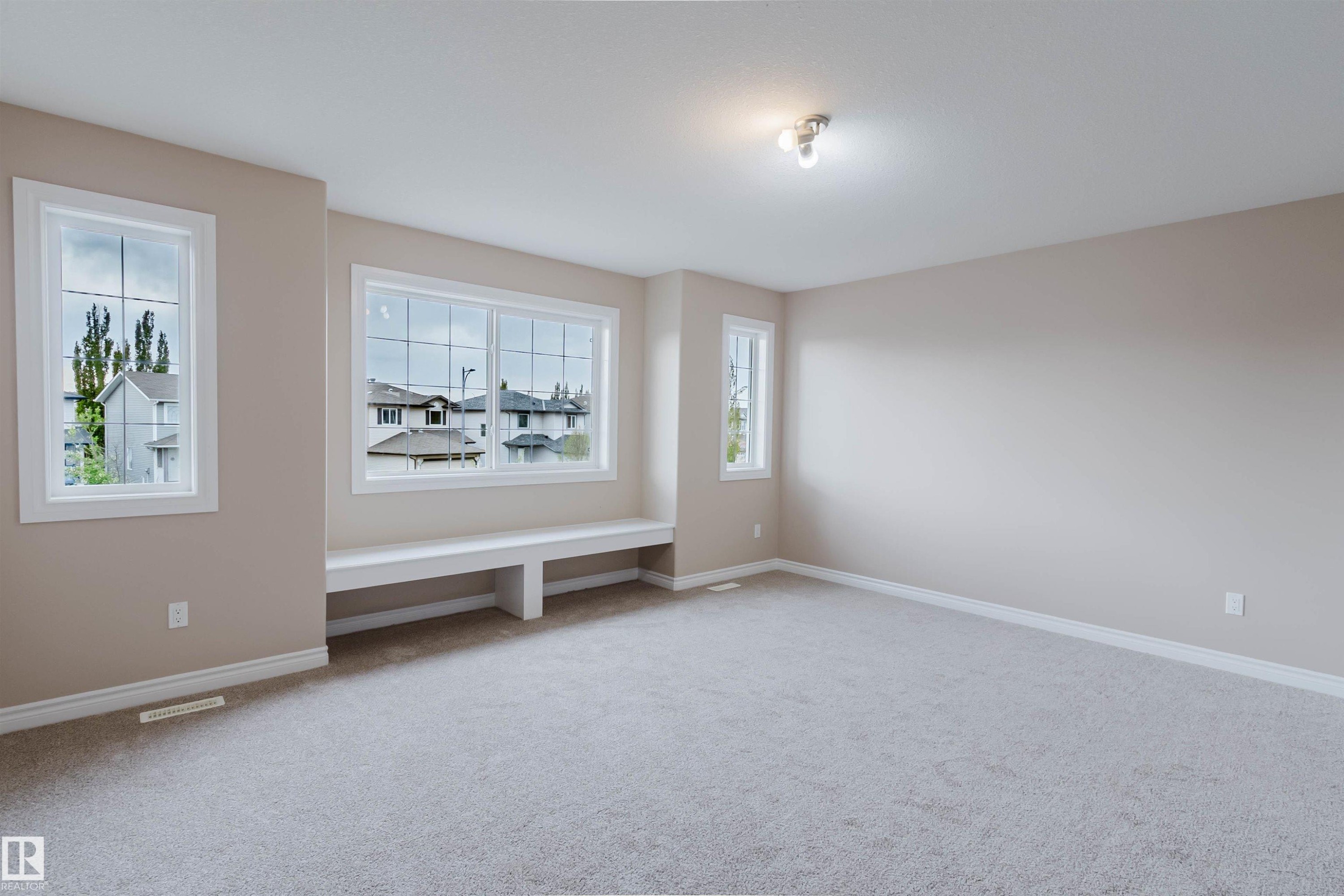 Spacious room featuring neutral carpeting and wall tones - 1919 Hammond Place, Edmonton, AB