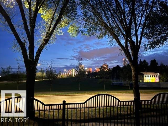 Black wrought iron fence with decorative top rail - #130 9008 99 Av Nw Nw, Edmonton, AB