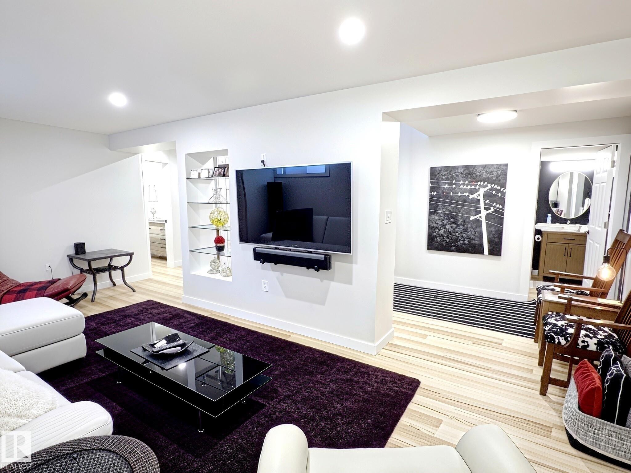 Recessed lighting illuminates this bright living space featuring wood-finish flooring - 17 10 Blackburn Drive, Edmonton, AB