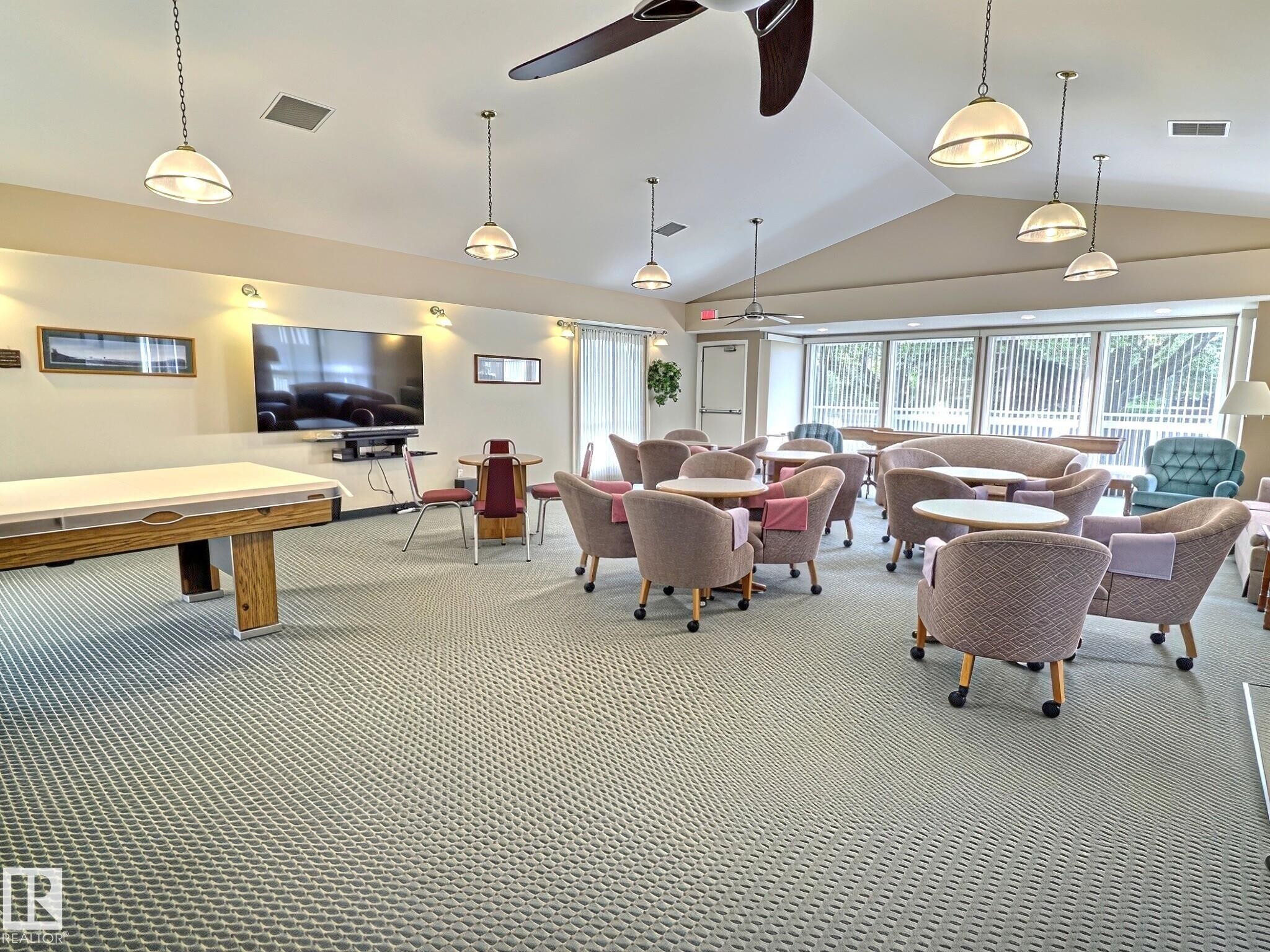 Spacious common area featuring vaulted ceilings, recessed lighting, and large windows - 17 10 Blackburn Drive, Edmonton, AB