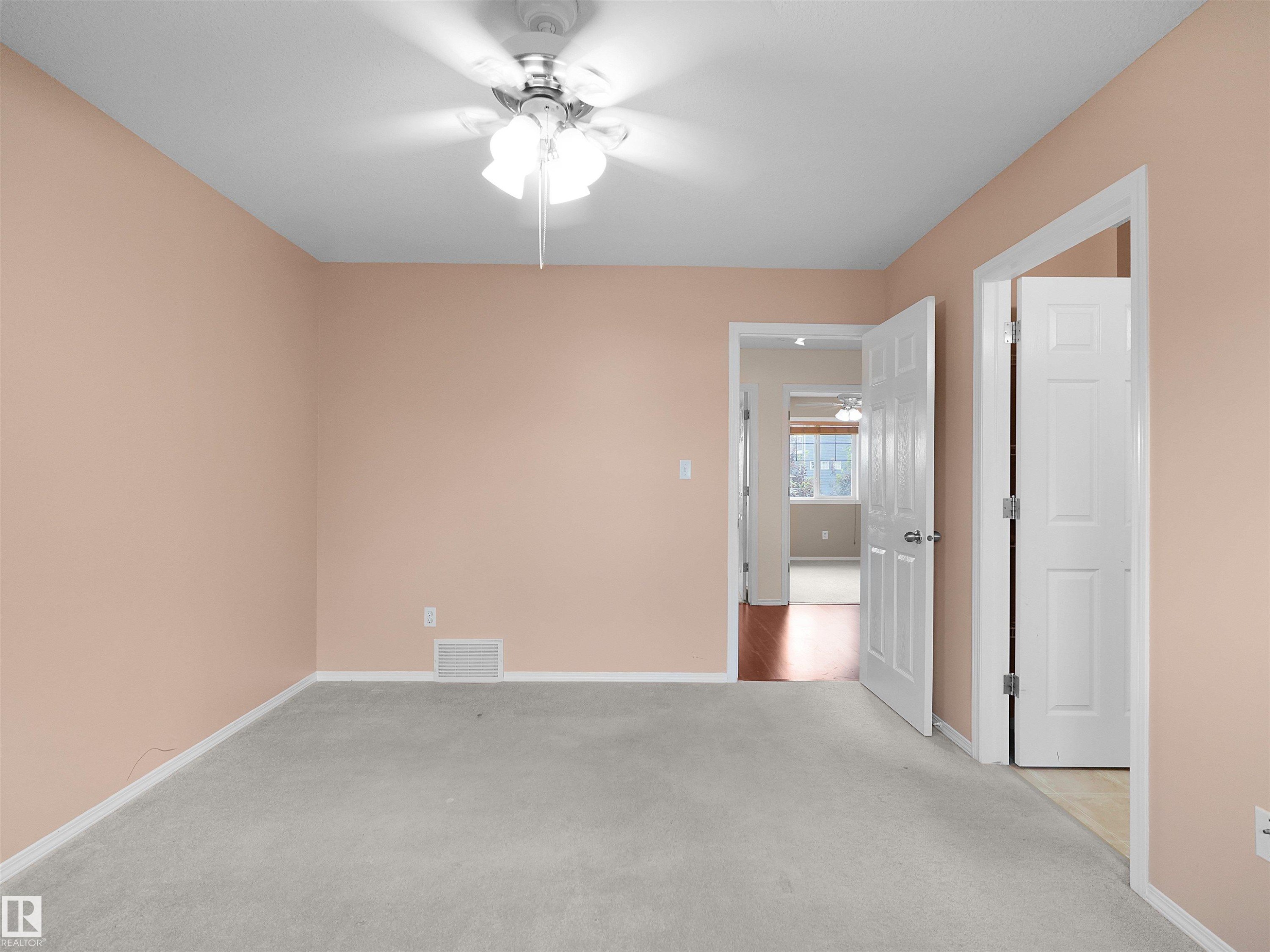 Interior room featuring light peach wall paint and light gray carpet flooring - 16106 131A Street Nw, Edmonton, AB - Indoor Photo Showing Other Room