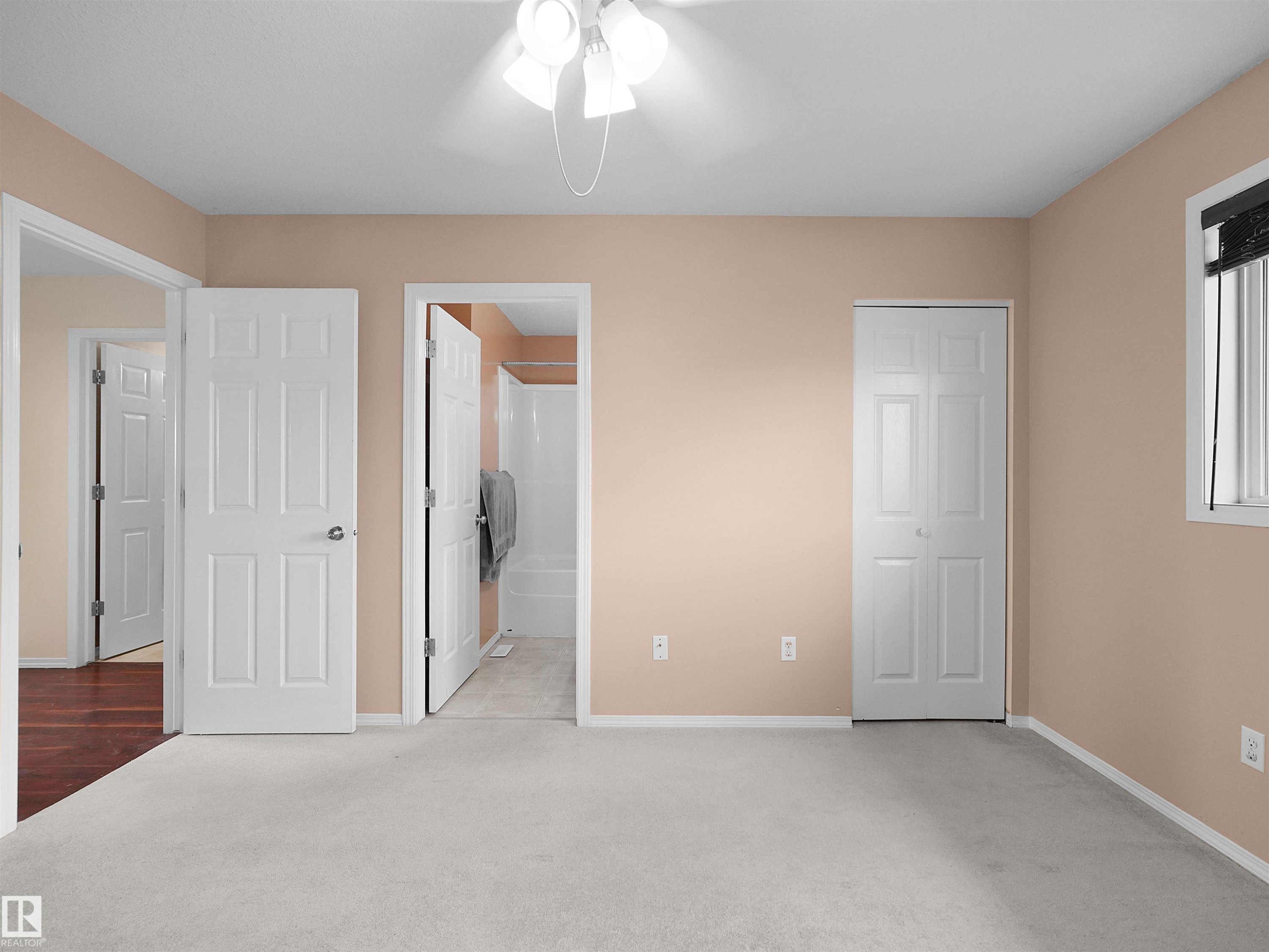 Carpeted room with peach-toned walls and white trim - 16106 131A Street Nw, Edmonton, AB - Indoor Photo Showing Other Room