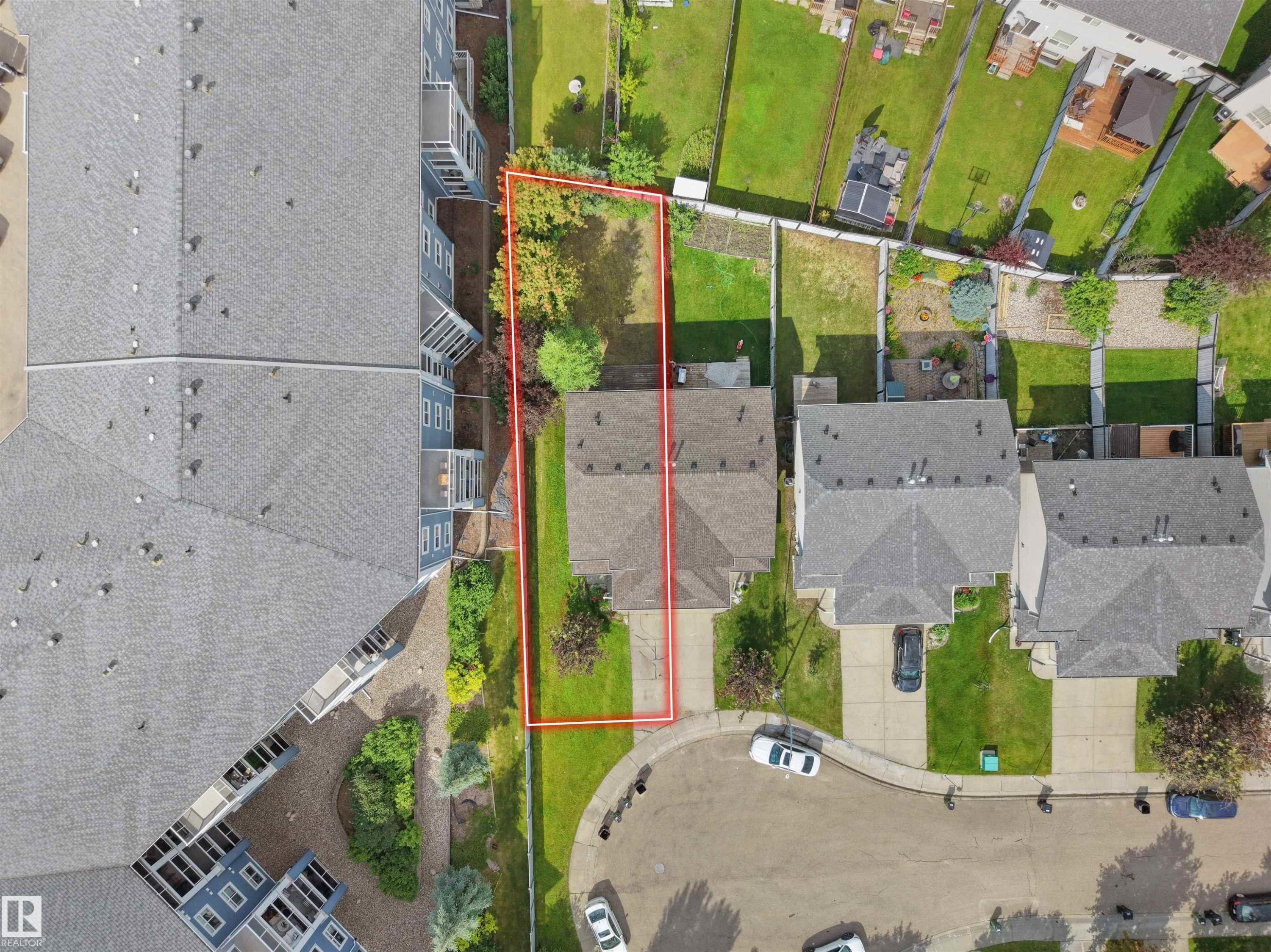 Aerial view showcasing a rectangular lot with mature trees and a grassy area - 16106 131A Street Nw, Edmonton, AB -