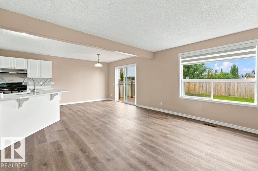 Spacious open-concept interior featuring light wood-finish flooring - 2811 33 Street, Edmonton, AB