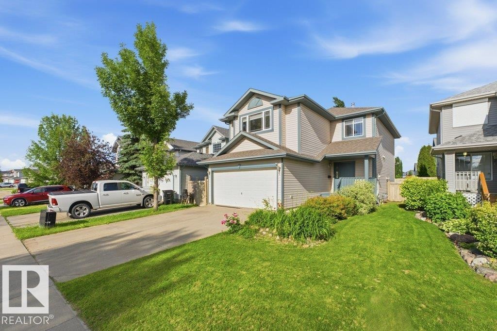 Two-story residence with light-colored siding and an attached garage - 2811 33 Street, Edmonton, AB
