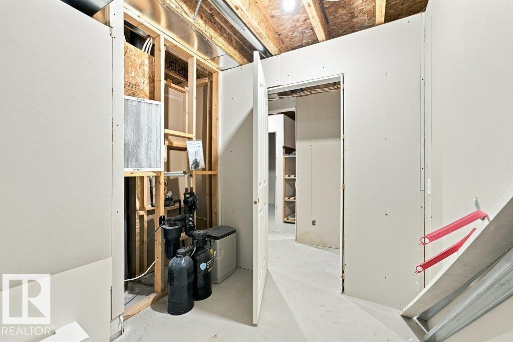 Unfinished interior space featuring exposed ceiling joists, drywall installation in progress, and visible utility systems - 2811 33 Street, Edmonton, AB