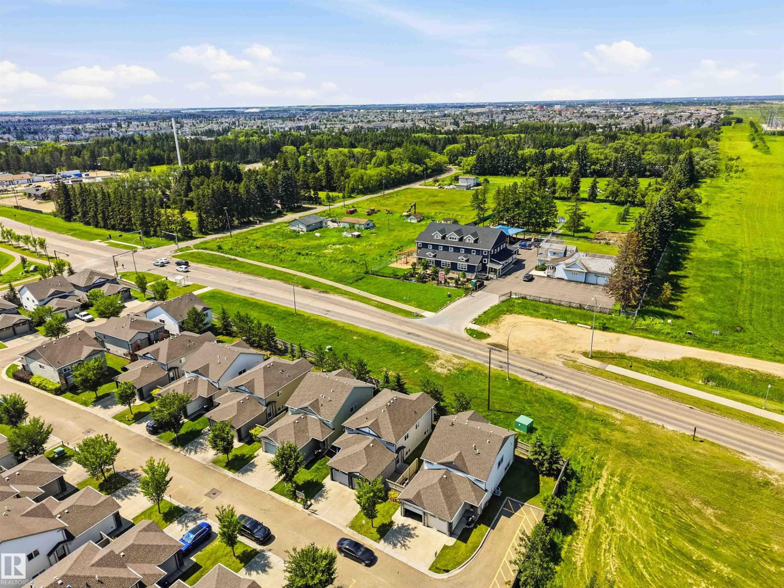 Residential neighborhood featuring detached properties with attached garages and paved driveways - 24 6520 2 Avenue, Edmonton, AB