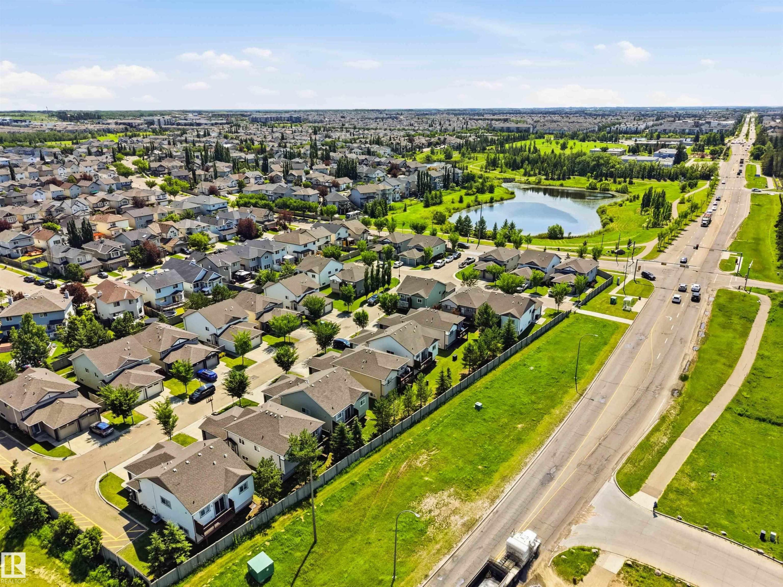 Aerial view of a residential community featuring numerous detached homes with pitched roofs and manicured lawns - 24 6520 2 Avenue, Edmonton, AB