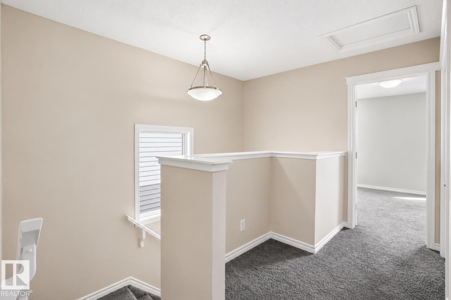 Open landing with plush grey carpeting and white trim details - 445 Watt Boulevard Sw, Edmonton, AB - Indoor Photo Showing Other Room