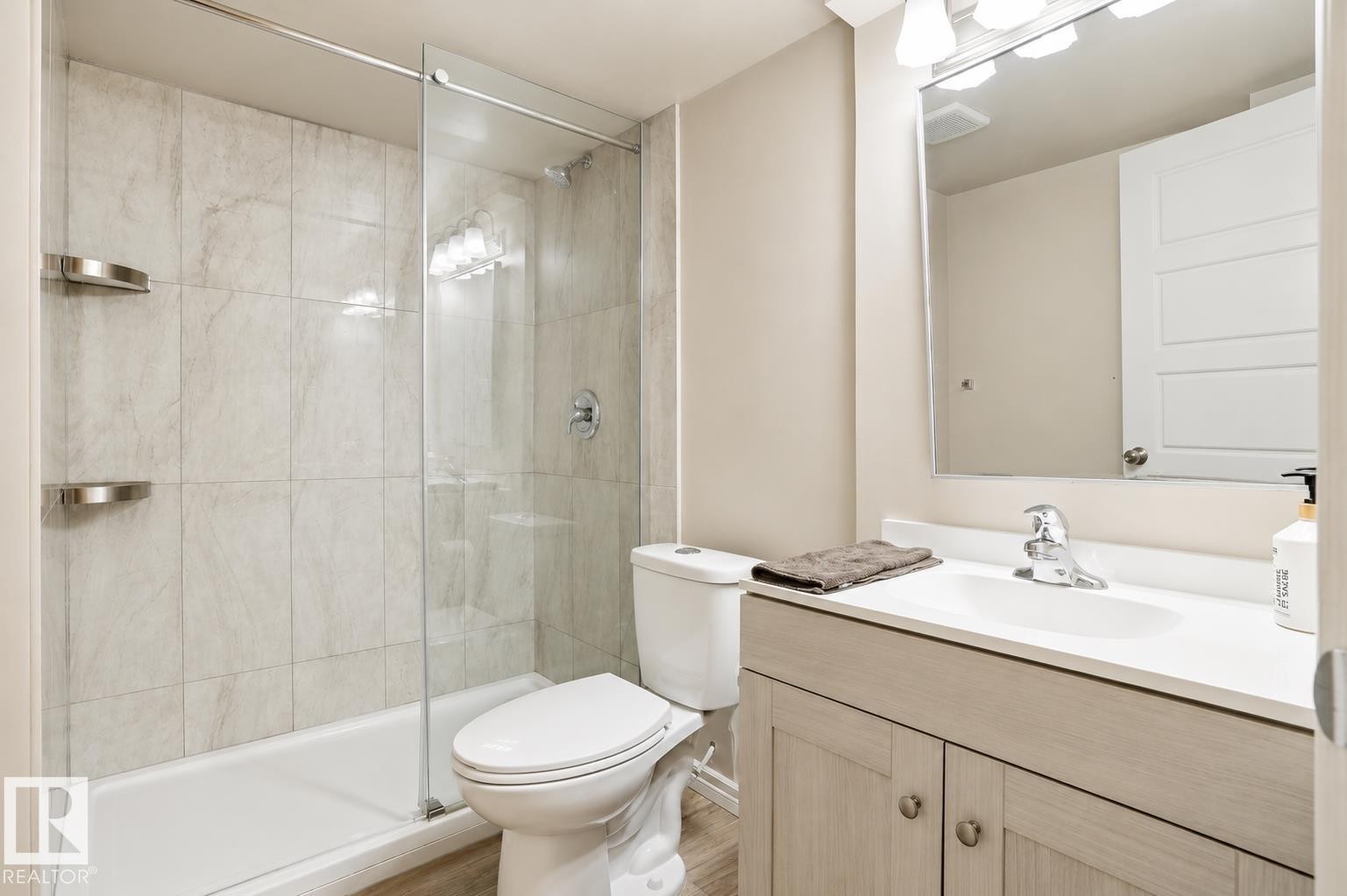 Basement Shower with glass enclosure, white square tile surround, and brushed nickel fixtures - 445 Watt Boulevard Sw, Edmonton, AB - Indoor Photo Showing Bathroom