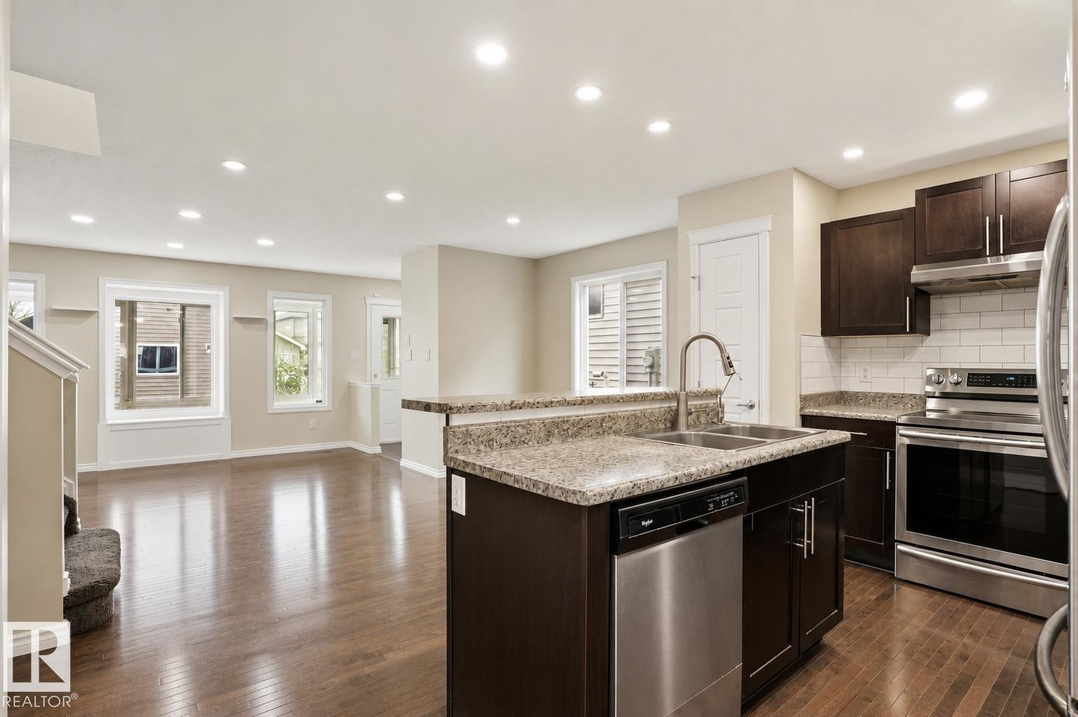 Kitchen featuring dark wood cabinetry, stainless steel appliances, and a tiled backsplash - 445 Watt Boulevard Sw, Edmonton, AB - Indoor Photo Showing Kitchen With Double Sink With Upgraded Kitchen