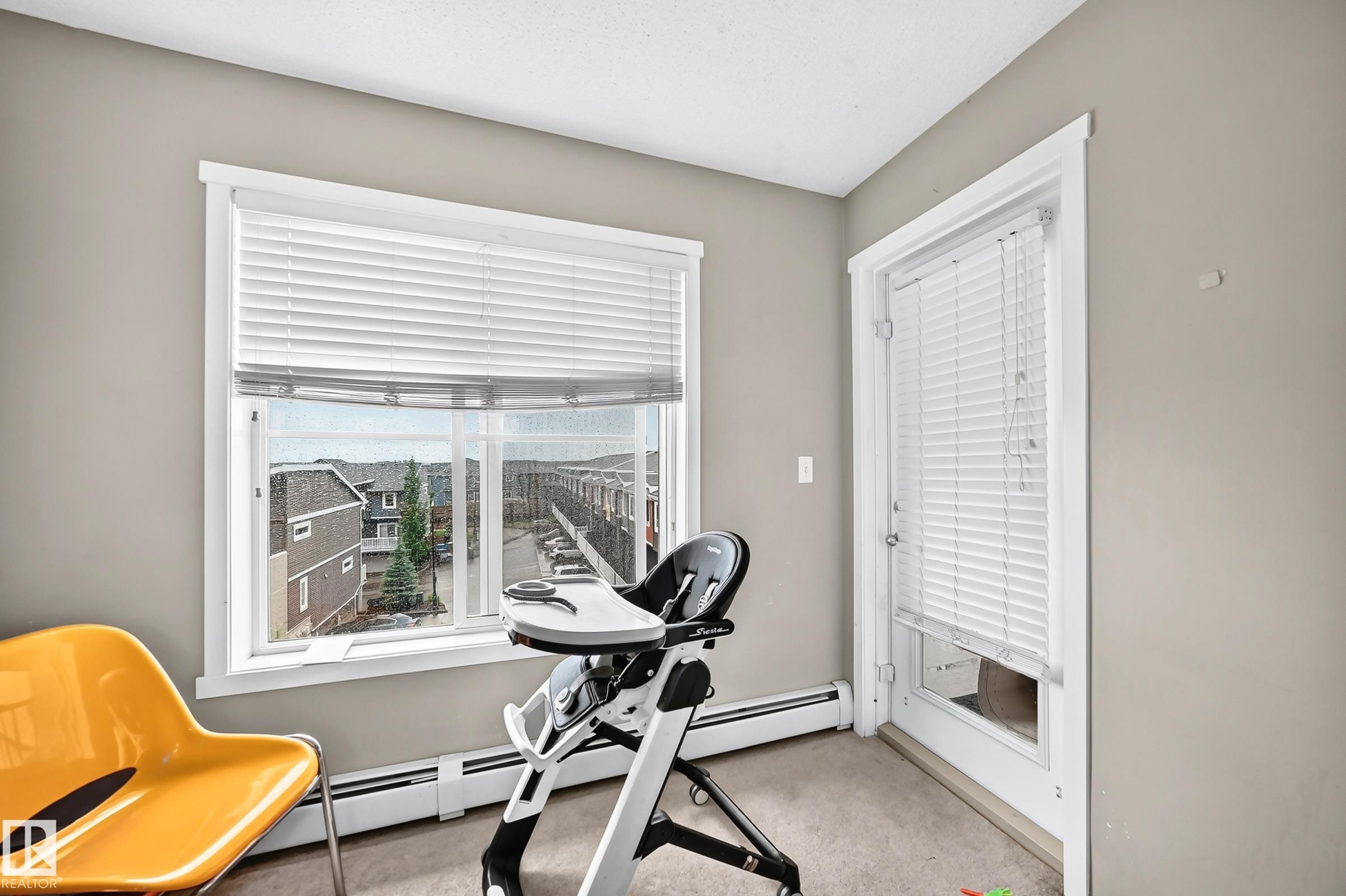 Room featuring neutral wall paint, white trim, and a window with horizontal blinds - #417 1510 Watt Dr Sw, Edmonton, AB - Indoor Photo Showing Gym Room